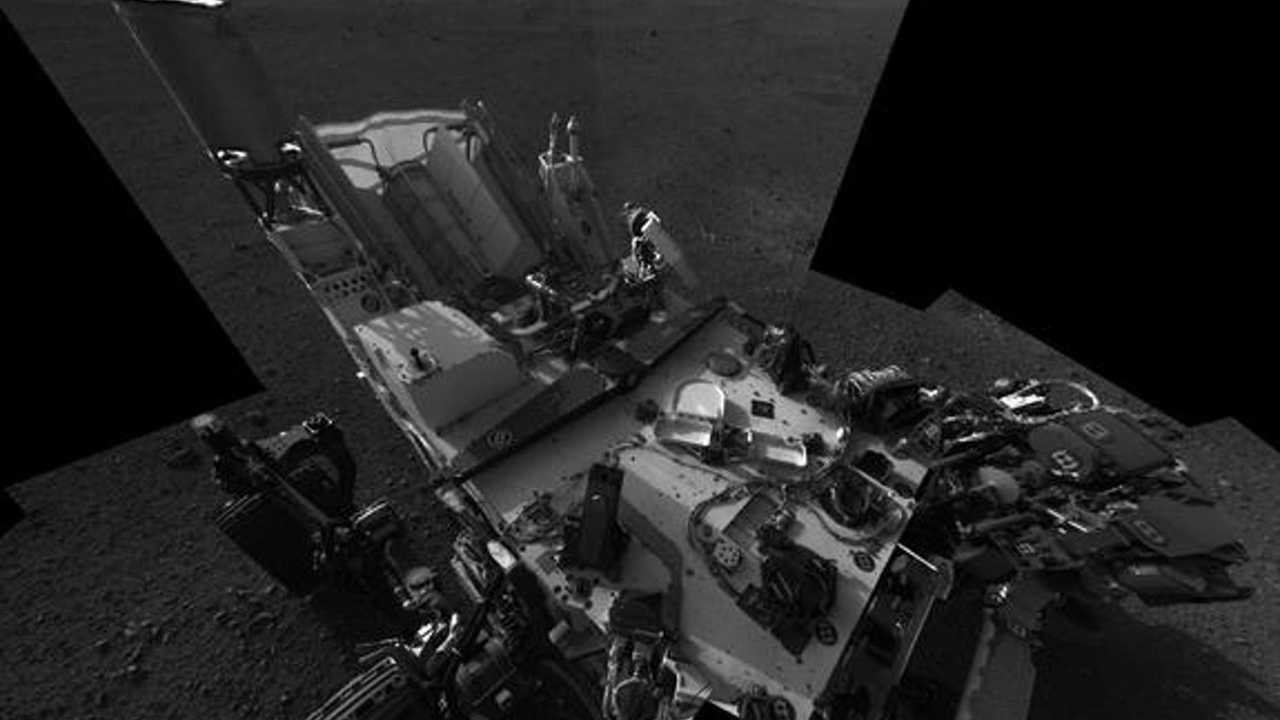This high-res mosaic of 20 images is the first clear self-portrait of NASA's Mars rover Curiosity on the Red Planet. The rear of the rover is at top, with two right-side wheels on the left. The rim of Gale Crater forms the lighter-color strip o