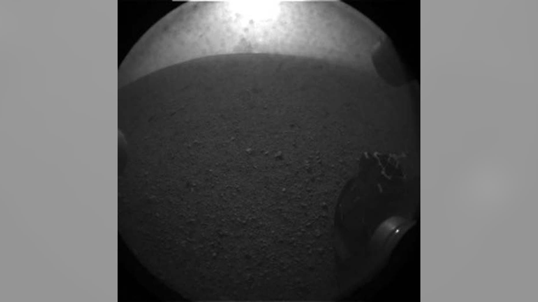 This photo shows one of the six wheels of NASA's huge rover Curiosity on Mars just after the rover's Aug. 5 PDT, 2012 landing in Gale Crater. This image is an enlarged version from the original 256-pixel image.