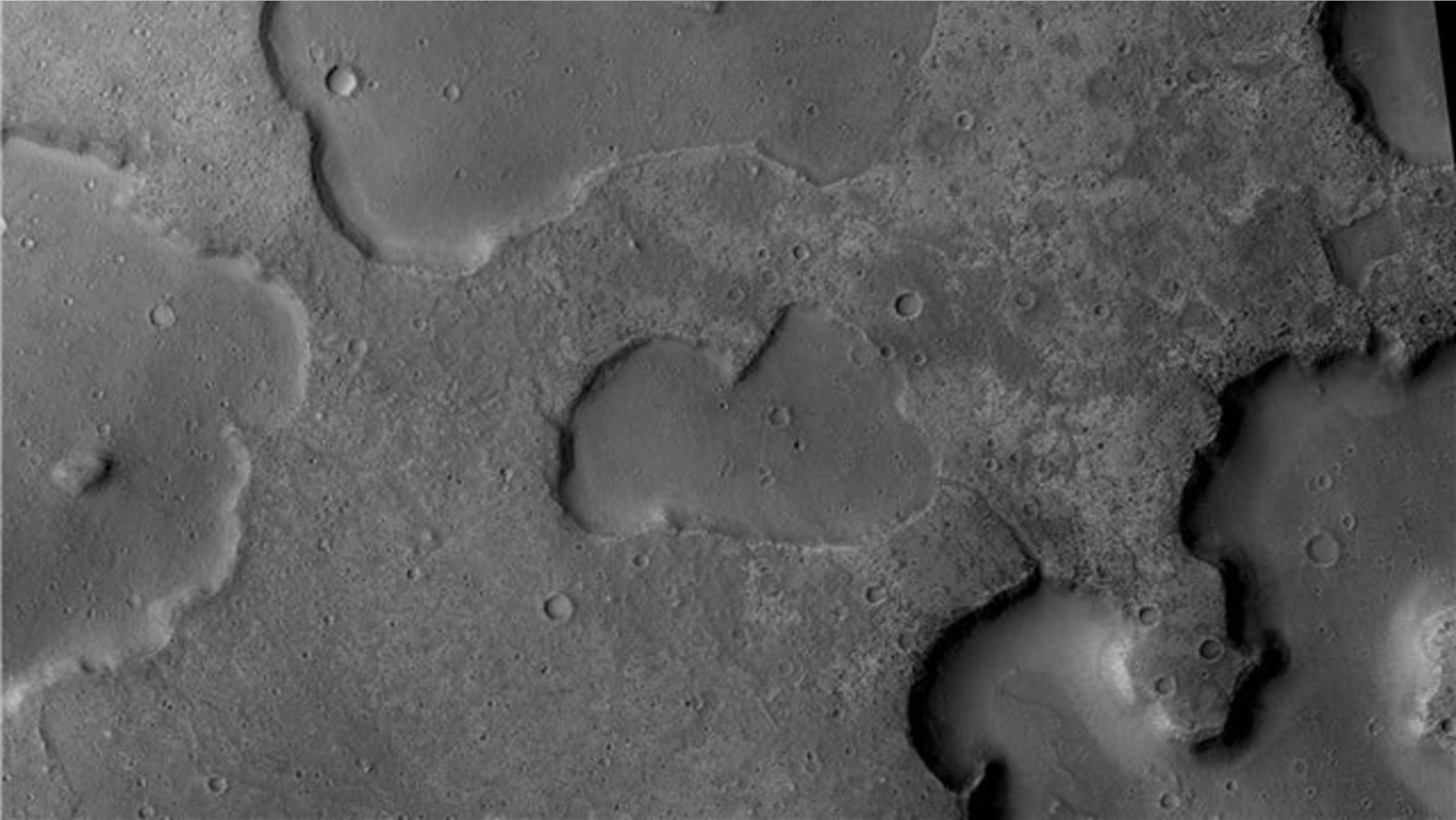 The Mars Reconnaisance Orbiter's Context Camera captured channels running between depressions, evidence of ancient drainage between lakes, researchers say. The central depression is 4 km wide.