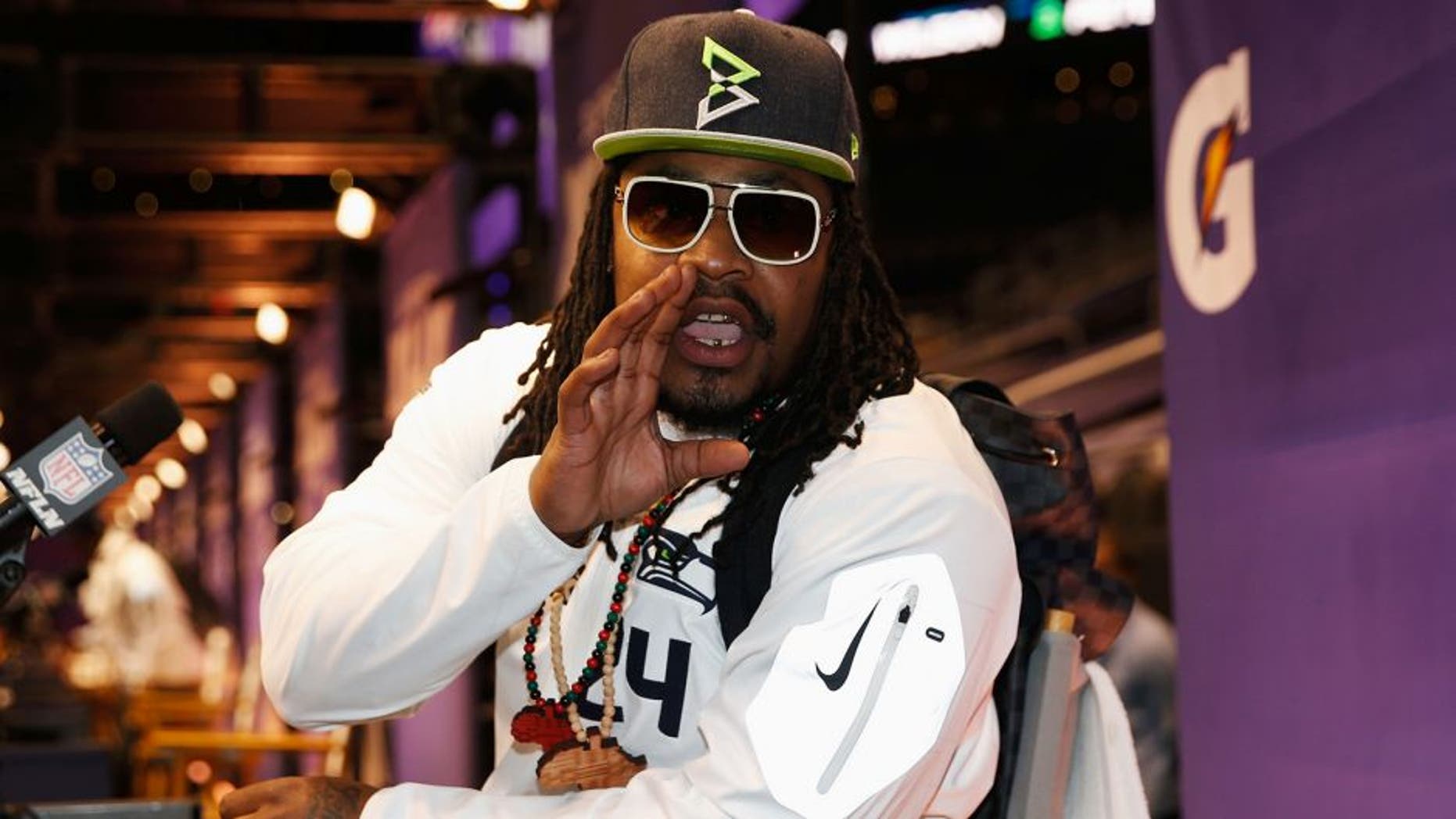 PHOENIX, AZ - JANUARY 27: Marshawn Lynch #24 of the Seattle Seahawks addresses the media at Super Bowl XLIX Media Day Fueled by Gatorade inside U.S. Airways Center on January 27, 2015 in Phoenix, Arizona. (Photo by Christian Petersen/Getty Images)