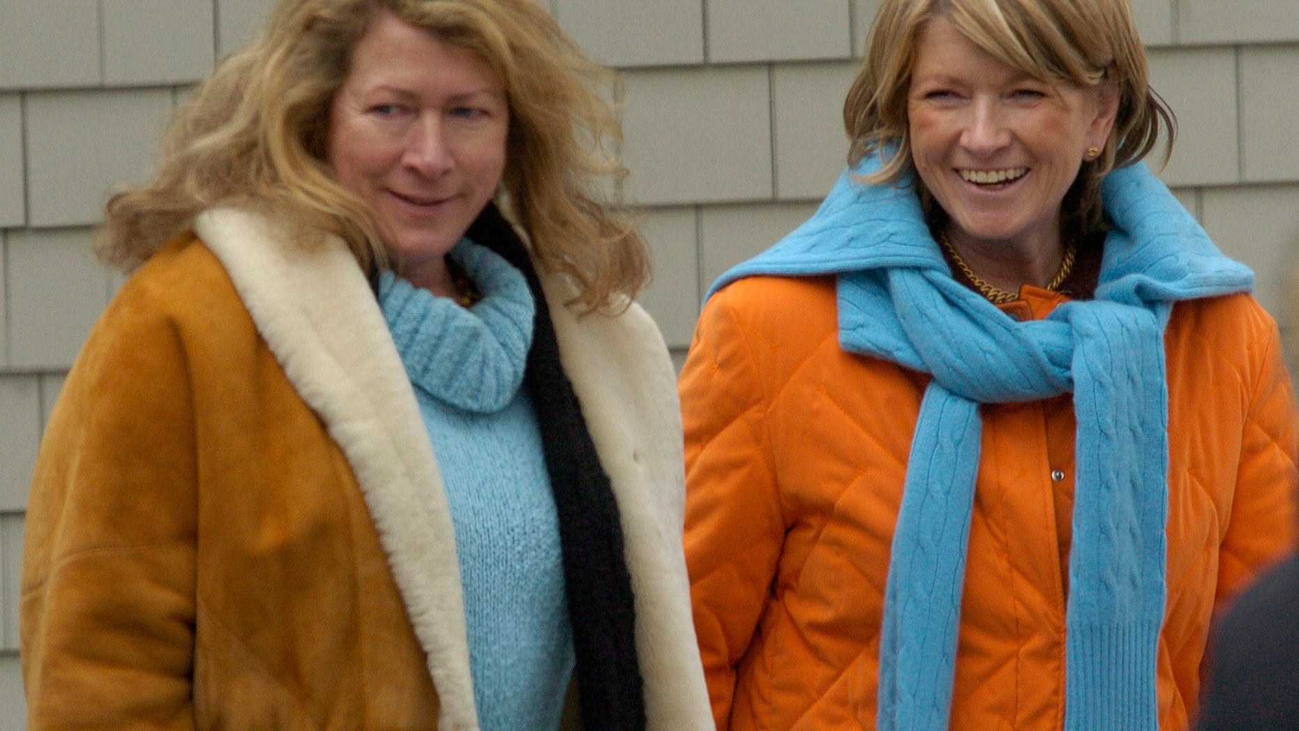 Martha Stewart (R) walks on the grounds of her estate with her sister Laura Plimpton (L) in Bedford, New York, March 6, 2005. Stewart, the lifestyle trendsetter who built a media empire, was released from prison and began five months of house arrest as she works to rehabilitate her image. REUTERS/Chip East CME - RTR44GE