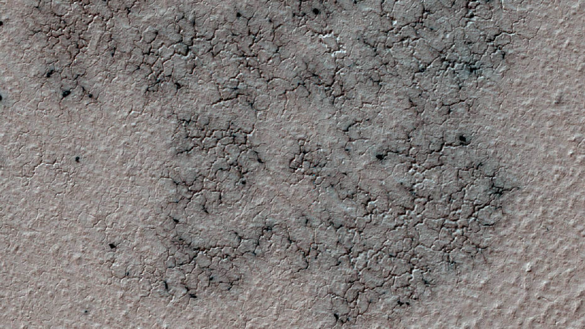 "Spidery" channels spotted near Mars' south pole by NASA's Mars Reconnaissance Orbiter.