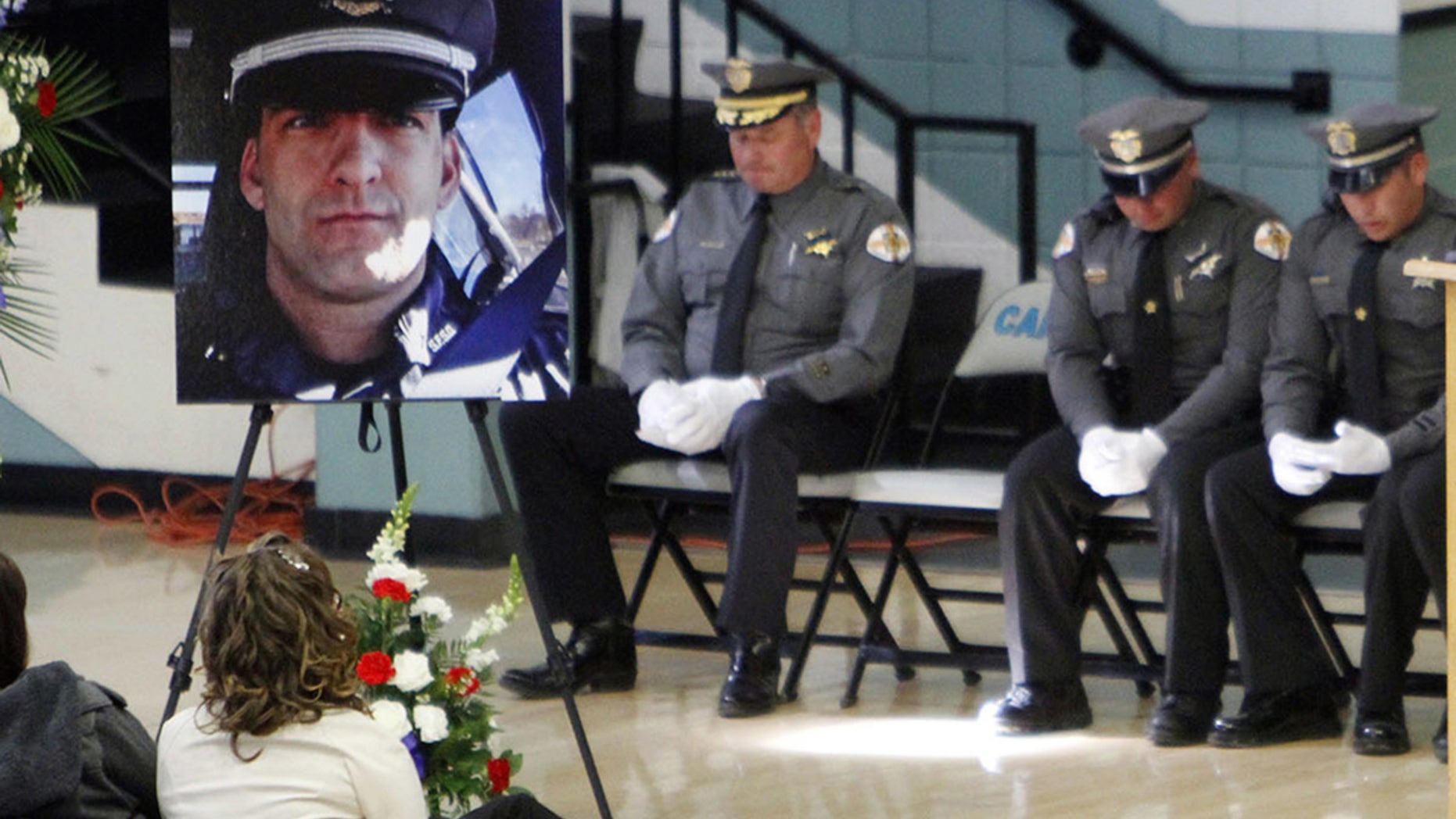 This Nov. 1, 2014 file photo shows a portrait of Santa Fe County Sheriff's Deputy Jeremy Martin during his memorial service.