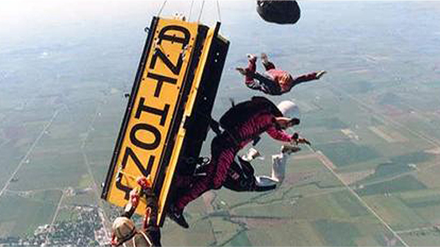 Escape artist Anthony Martin of Sheboygan, Wis., escapes from a wooden box that was locked and pushed out of a plane at 13,500 feet in August 1988, in Sandwich, Ill.