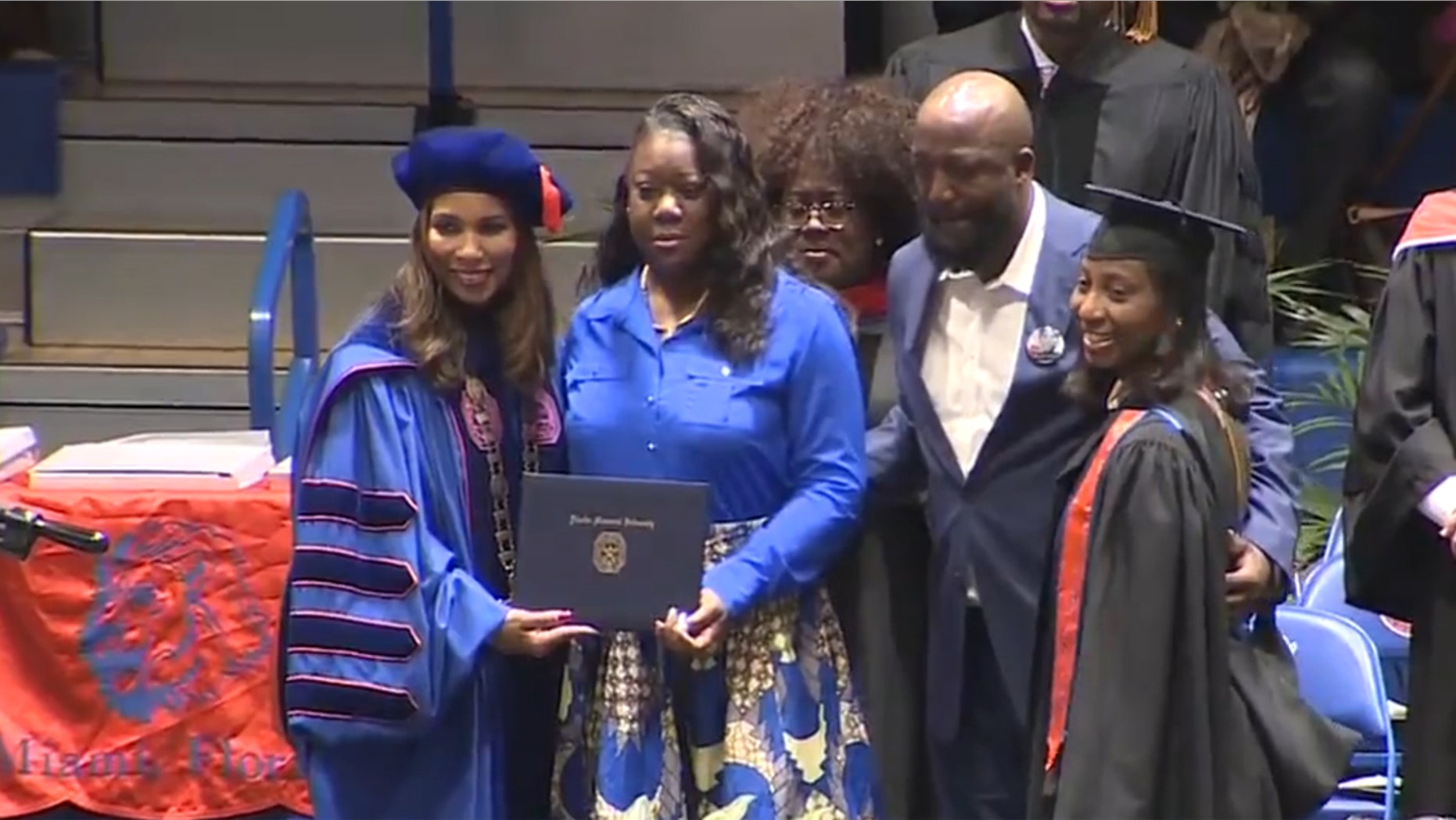 Trayvon Martin’s parents, Sybrina Fulton and Tracy Martin, take the stage at Florida Memorial University’s commencement to receive a posthumous bachelor’s degree in aeronautical science on their son’s behalf.