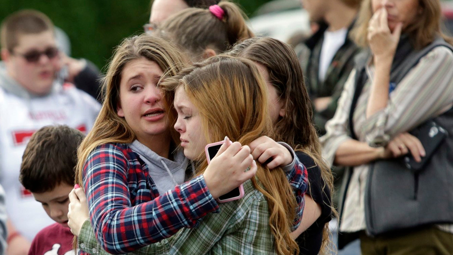 Two girls hug at Shoultes Gospel Hall church where families are reuniting after an active shooter situation at Marysville-Pilchuck High School in Marysville, Washington October 24, 2014. REUTERS/Jason Redmond