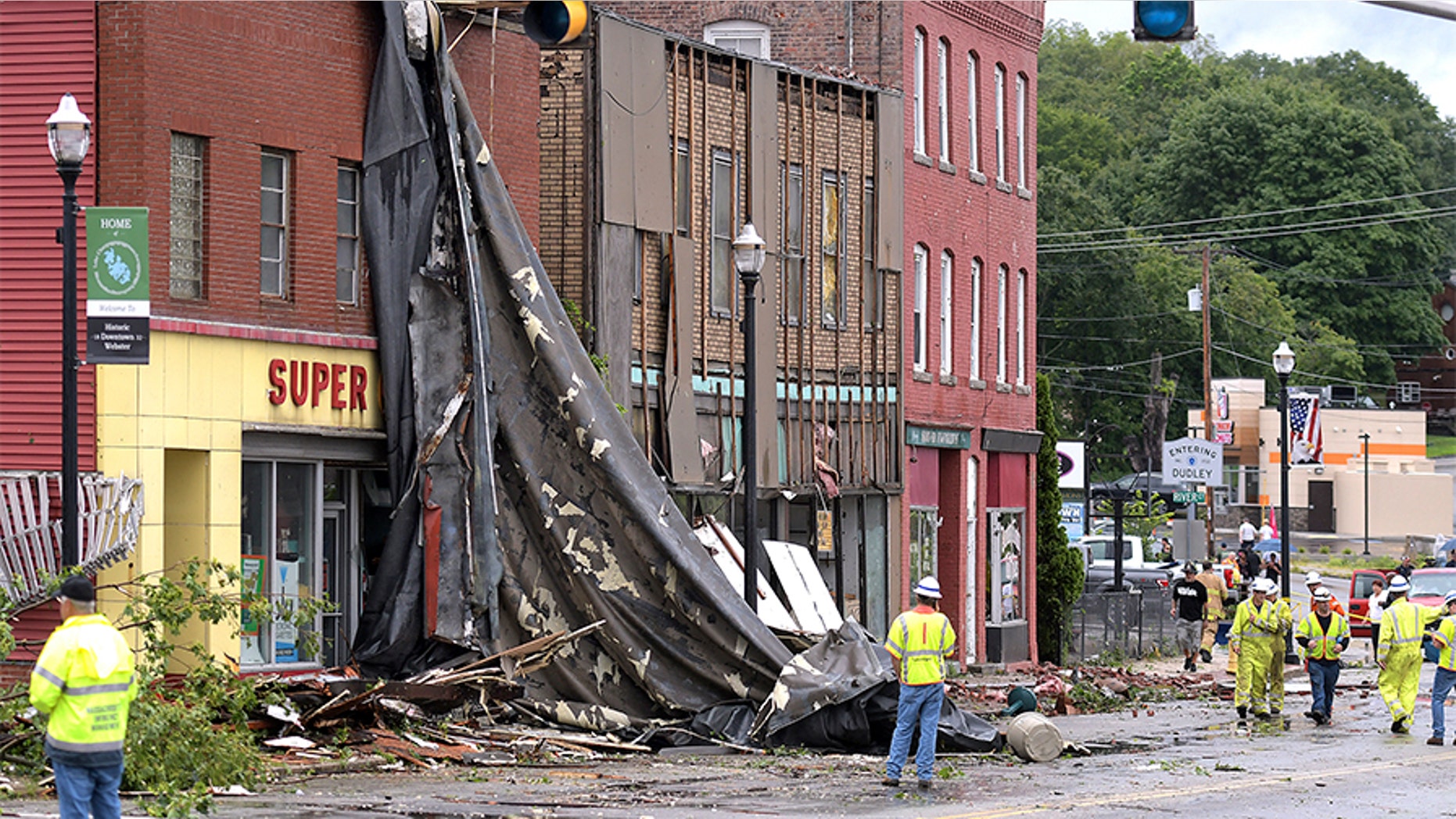 A building suffers damage to its roof after a storm passed on Saturday in Webster, Mass. Officials say a tornado touched down in the Massachusetts town near the Connecticut border. The National Weather Service confirmed the tornado but didn't know its strength. The tornado caused structural damage to buildings and downed trees and poles.