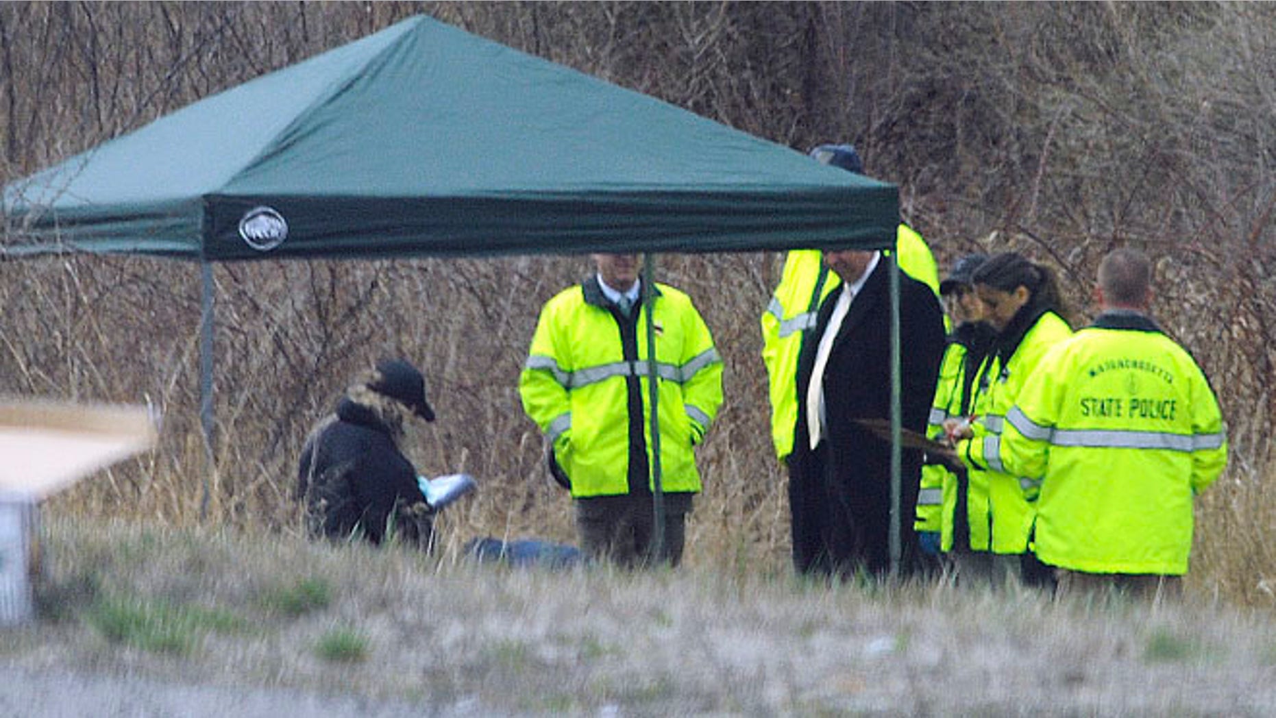 Apr. 18, 2014: Massachusetts State Police stand along Interstate 190 where police said a child's body was found near Sterling, Mass.