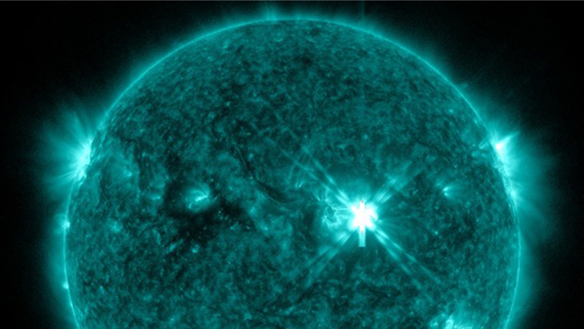 Sept. 6, 2011: This image taken by NASA's Solar Dynamics Observatory watching the sun shows a powerful solar flare (center right) just minutes after it erupted on 6:20 p.m. EDT (2220 GMT).
