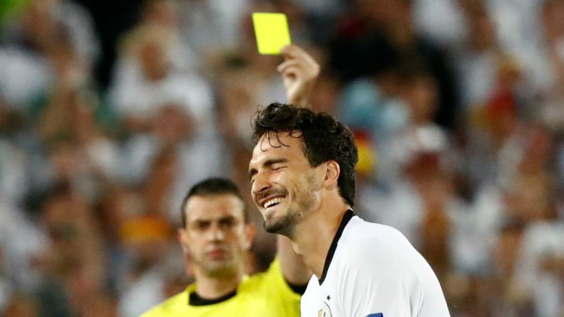 Football Soccer - Germany v Italy - EURO 2016 - Quarter Final - Stade de Bordeaux, Bordeaux, France - 2/7/16 Germany's Mats Hummels is booked by referee Viktor Kassai REUTERS/Christian Hartmann Livepic