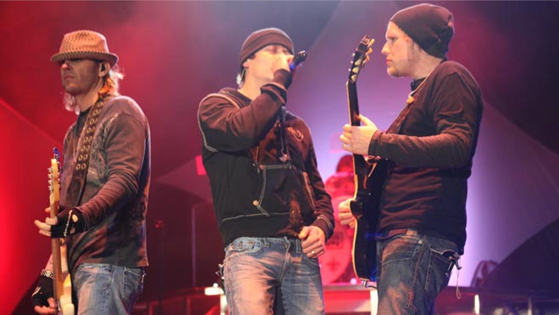 Matt Roberts (r.) performs with 3 Doors Down bandmates Todd Harrell (l.) and Brad Arnold in 2011.