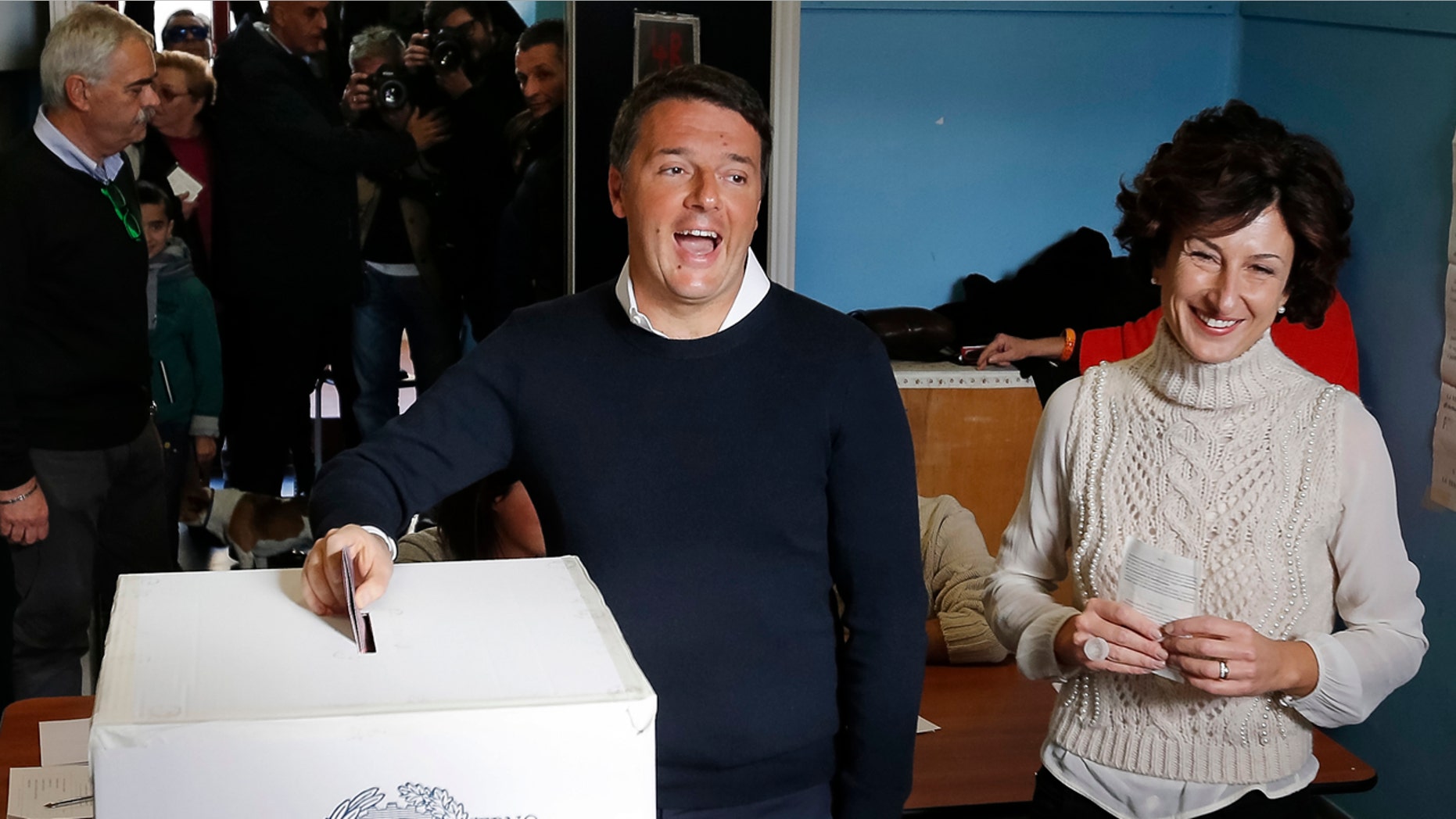 Dec. 4, 2016: Italian Premier Matteo Renzi is flanked by his wife Agnese as he casts his ballot at a polling station in Pontassieve, Italy.