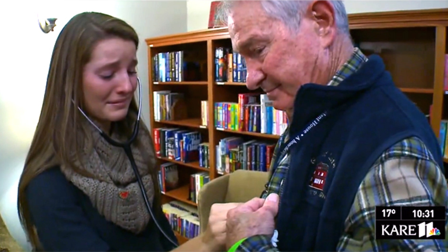 Casey Heilser, listens to the chest of Tom Meeks who received her brother Matt's heart in a life-saving transplant.