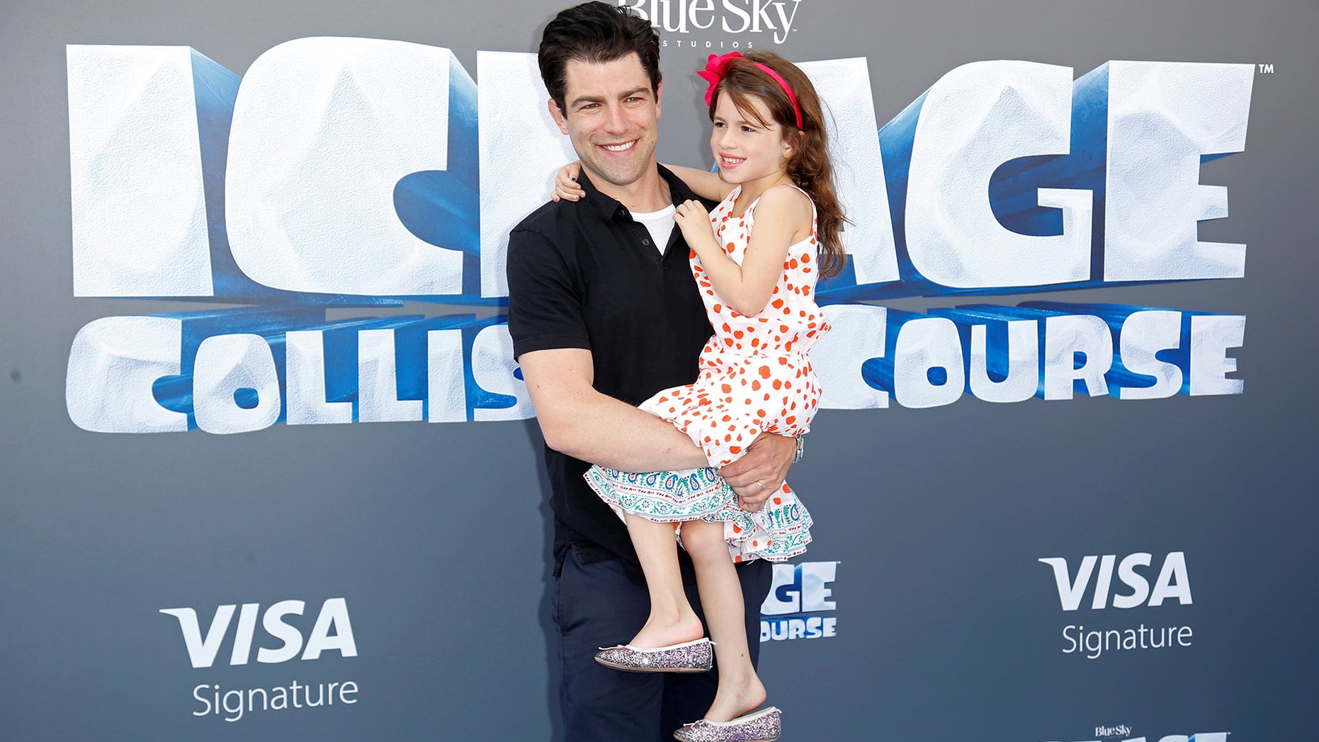 Cast member Max Greenfield (L) and his daughter Lily pose at a screening of the movie "Ice Age: Collision Course" at the Fox Studios Lot in Los Angeles, California, U.S., July 16, 2016.