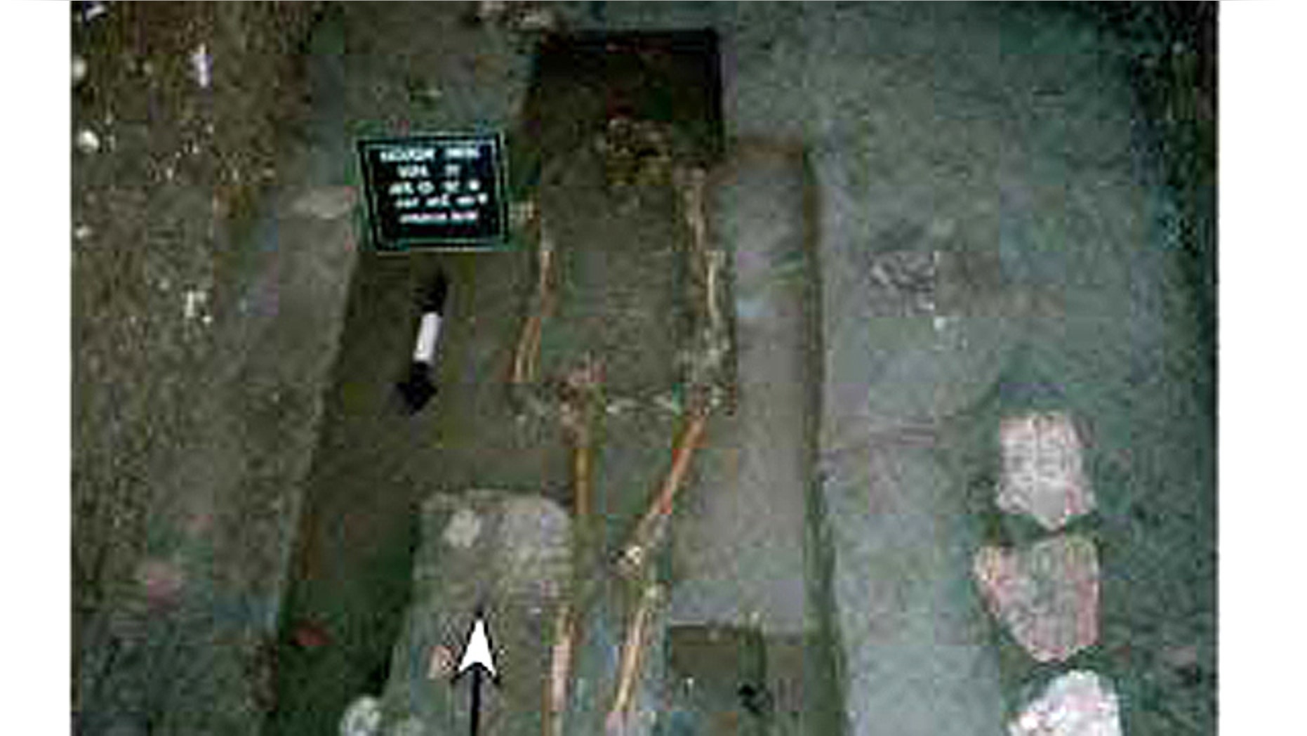 The torso and pelvis of this body, found in the floor of one of the homes Lucero excavated, had been removed. A matate and mano, used for grinding corn, were found near the right knee. A deer antler and pink quartzite stone were buried beneath the chest area.