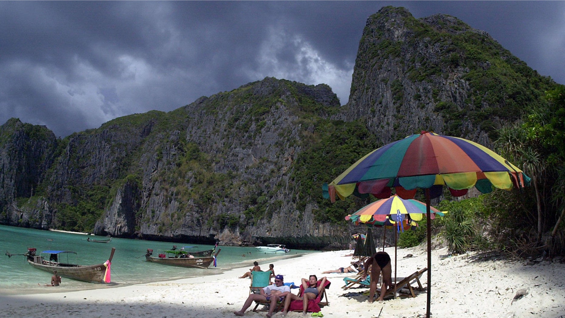 Tourists catch the sun's rays on remote Maya Beach in southern Thailand, made famous as the shooting location of the Leonardo DiCaprio movie, "The Beach."