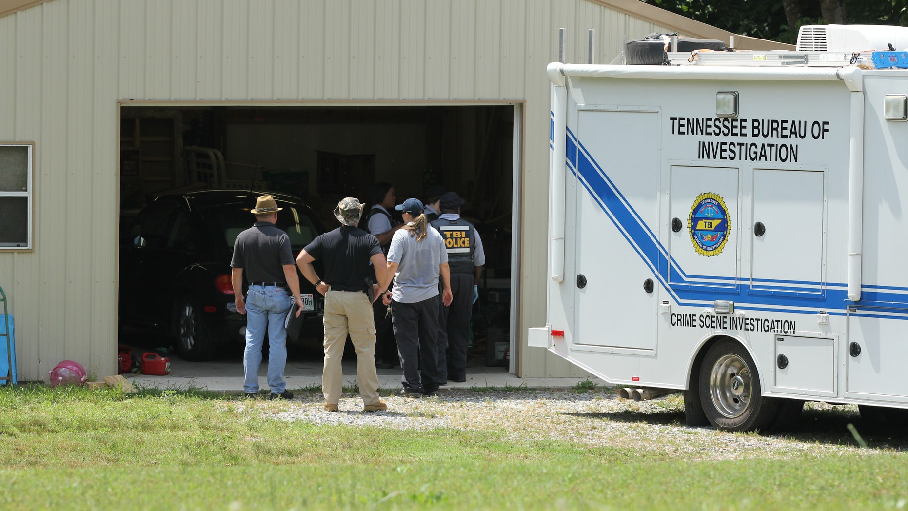 May 6, 2012: Tennessee Bureau of Investigation agents inspect the home and garage of a woman and her three young daughters who authorities say were abducted near Whiteville, Tenn.