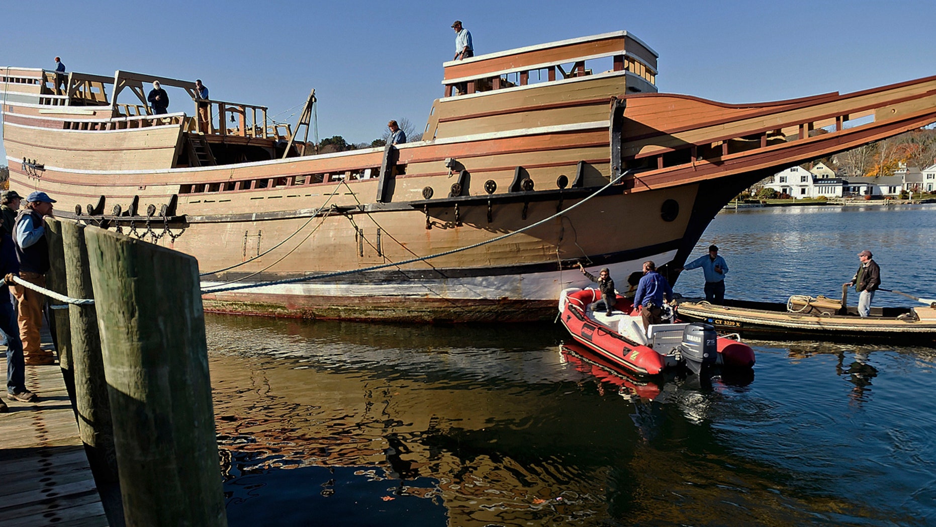 In this Nov. 18, 2016 photo, workers at Mystic Seaport move the Mayflower II from the dock into the ship-lift to be hauled out of the Mystic River at the Henry B. duPont Preservation Shipyard in Stonington, Conn.