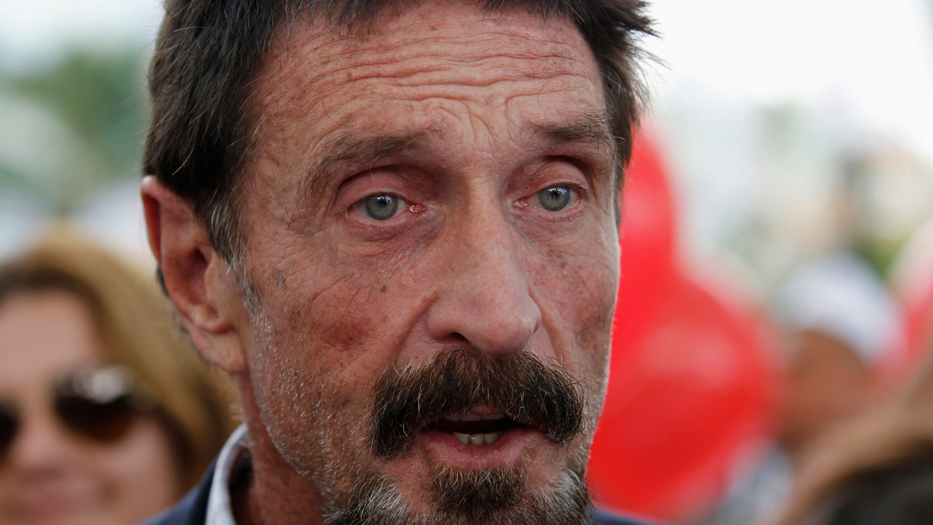 File photo - Computer software pioneer John McAfee speaks with reporters outside his hotel in Miami Beach, Florida December 13, 2012.(REUTERS/Joe Skipper)