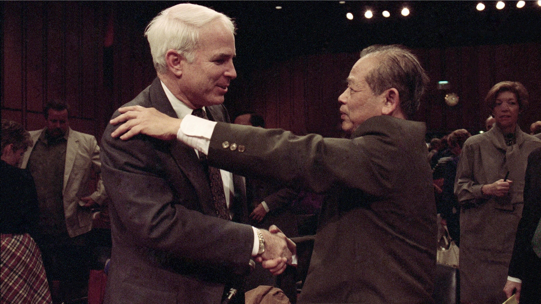 In this Nov. 7, 1991, file photo, Sen. John McCain, R-Ariz., left, is hugged by former North Vietnam Col. Bui Tin on Capitol Hill in Washington after a hearing of the Senate Select Committee on POW and MIA affairs. Tin oversaw a military prison operation dubbed the "Hanoi Hilton," where McCain was held prisoner during the Vietnam War. McCain, the war hero who became the GOP's standard-bearer in the 2008 election, died Saturday, Aug. 25, 2018. He was 81.
