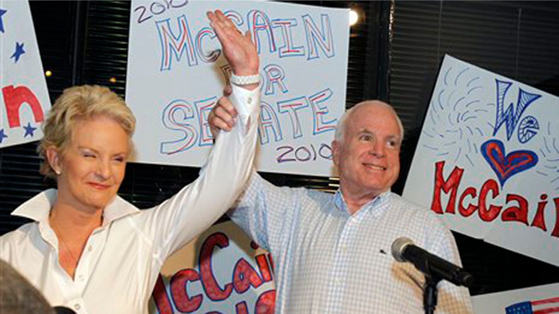 Aug. 23: Sen. John McCain with his wife Cindy McCain gets applause from supporters in Phoenix. (AP Photo)