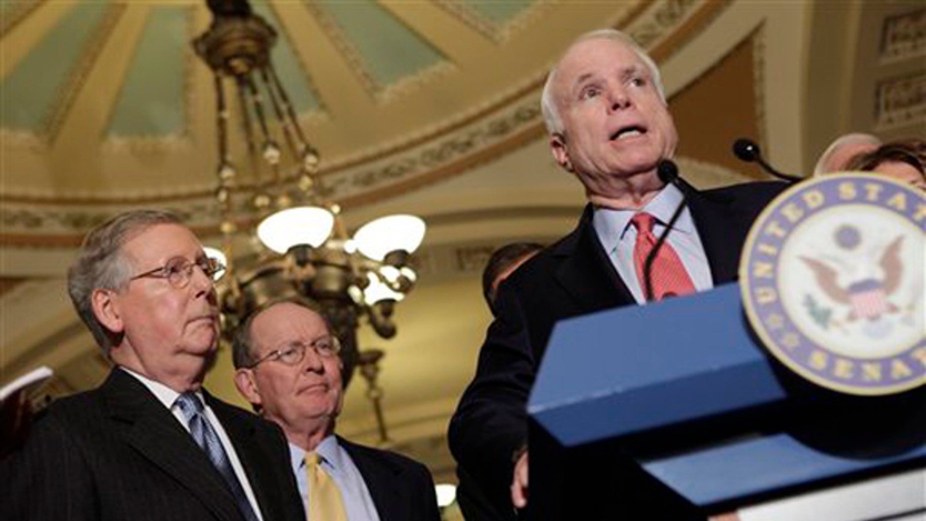 Sen. John McCain, right, speaks on Capitol Hill Dec. 1, accompanied by Senate Minority Leader Mitch McConnell, left, and Sen. Lamar Alexander. (AP Photo)