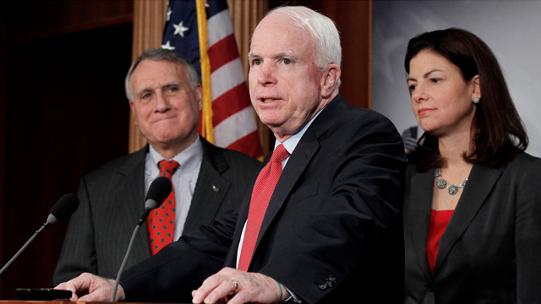 Dec. 14, 2011: Sen. John McCain, R-Ariz., ranking Republican on the Senate Armed Services Committee, center, flanked by Senate Minority Whip Jon Kyl of Ariz., and fellow committee member Sen. Kelly Ayotte, R-N.H., speaks during a news conference on Capitol Hill in Washington to announce an effort to replace the defense sequester mandated as a result of the Supercommittee's failure.