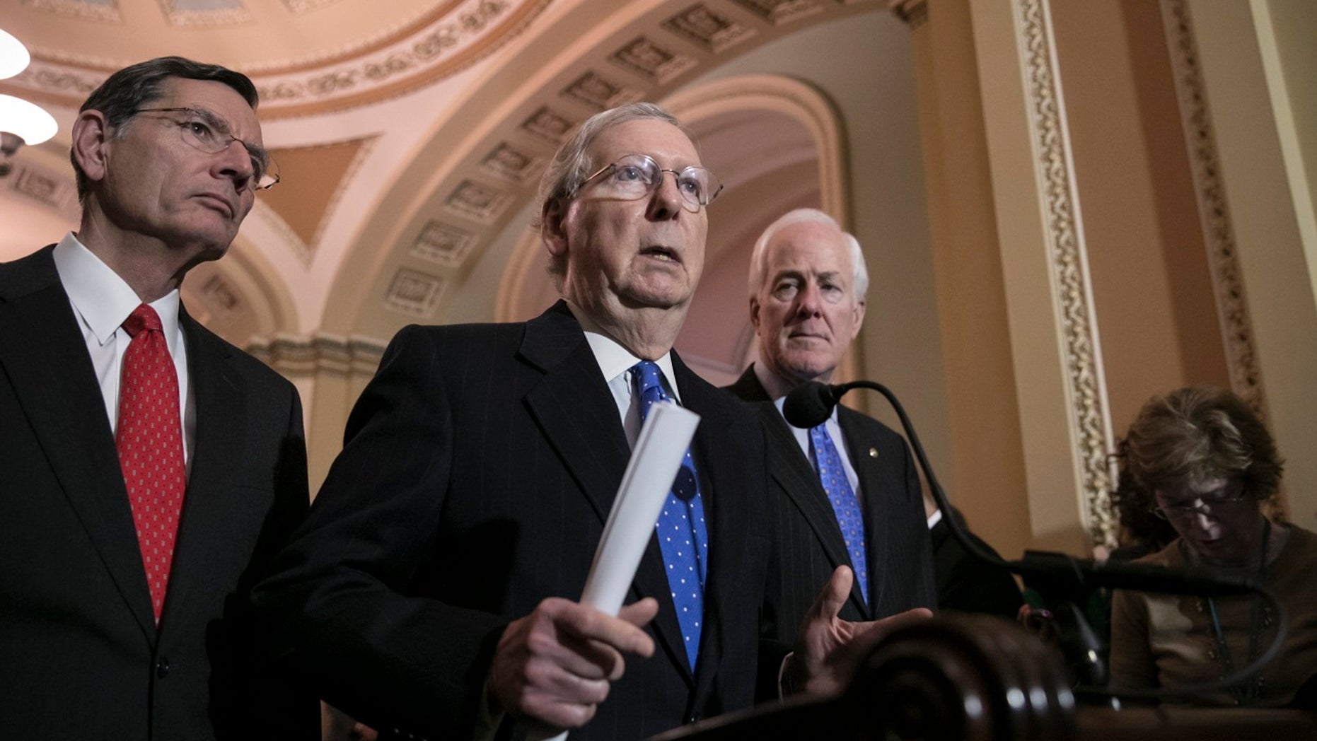 Senate Majority Leader Mitch McConnell, R-Ky., center, addresses reporters about the federal government shutdown.