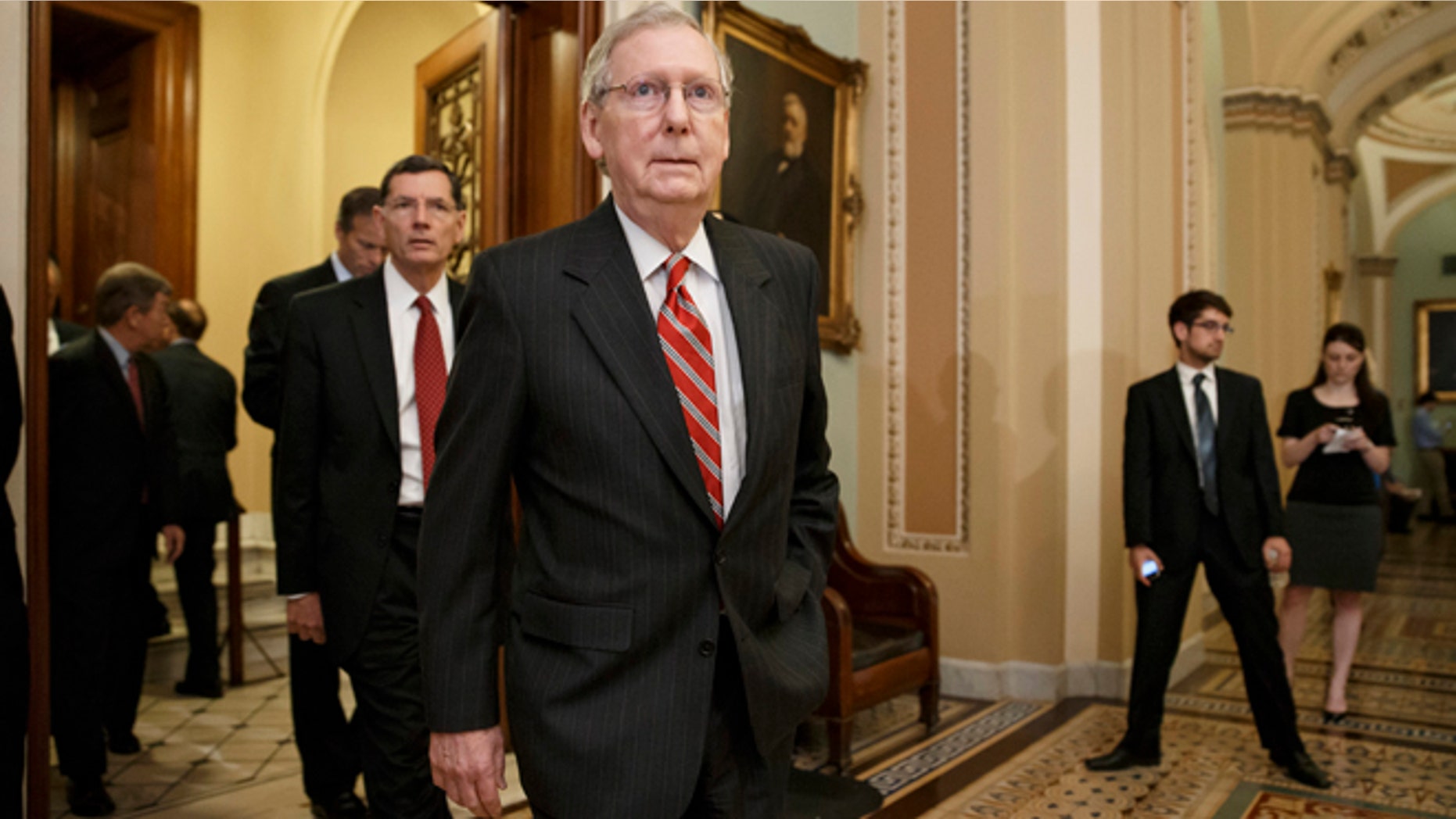 May 13, 2014: Senate Minority Leader Mitch McConnell of Ky. and other GOP lawmakers walk to meet reporters after a Republican caucus meeting on Capitol Hill in Washington.