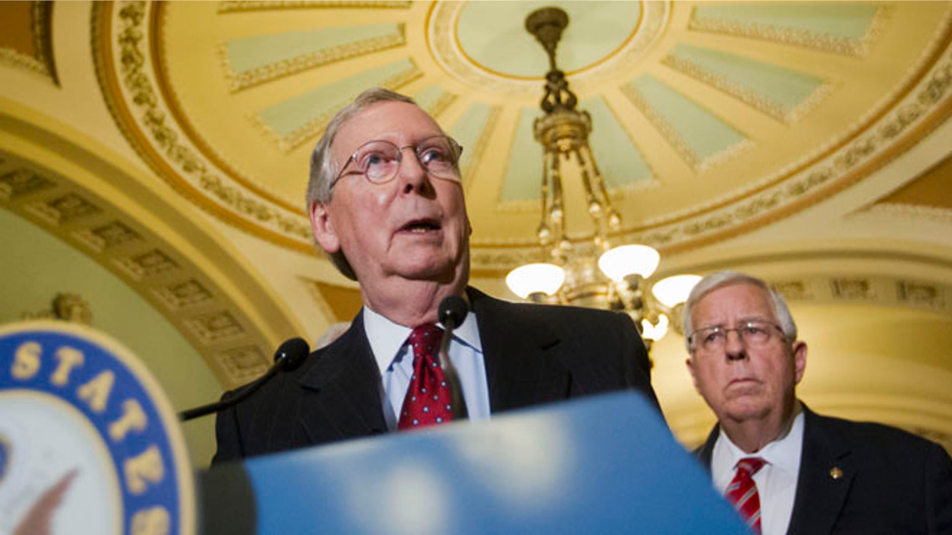 March 24, 2015: Senate Majority Leader Mitch McConnell of Ky., accompanied by Sen. Mike Enzi, R-Wyo., speaks to reporters on Capitol Hill.