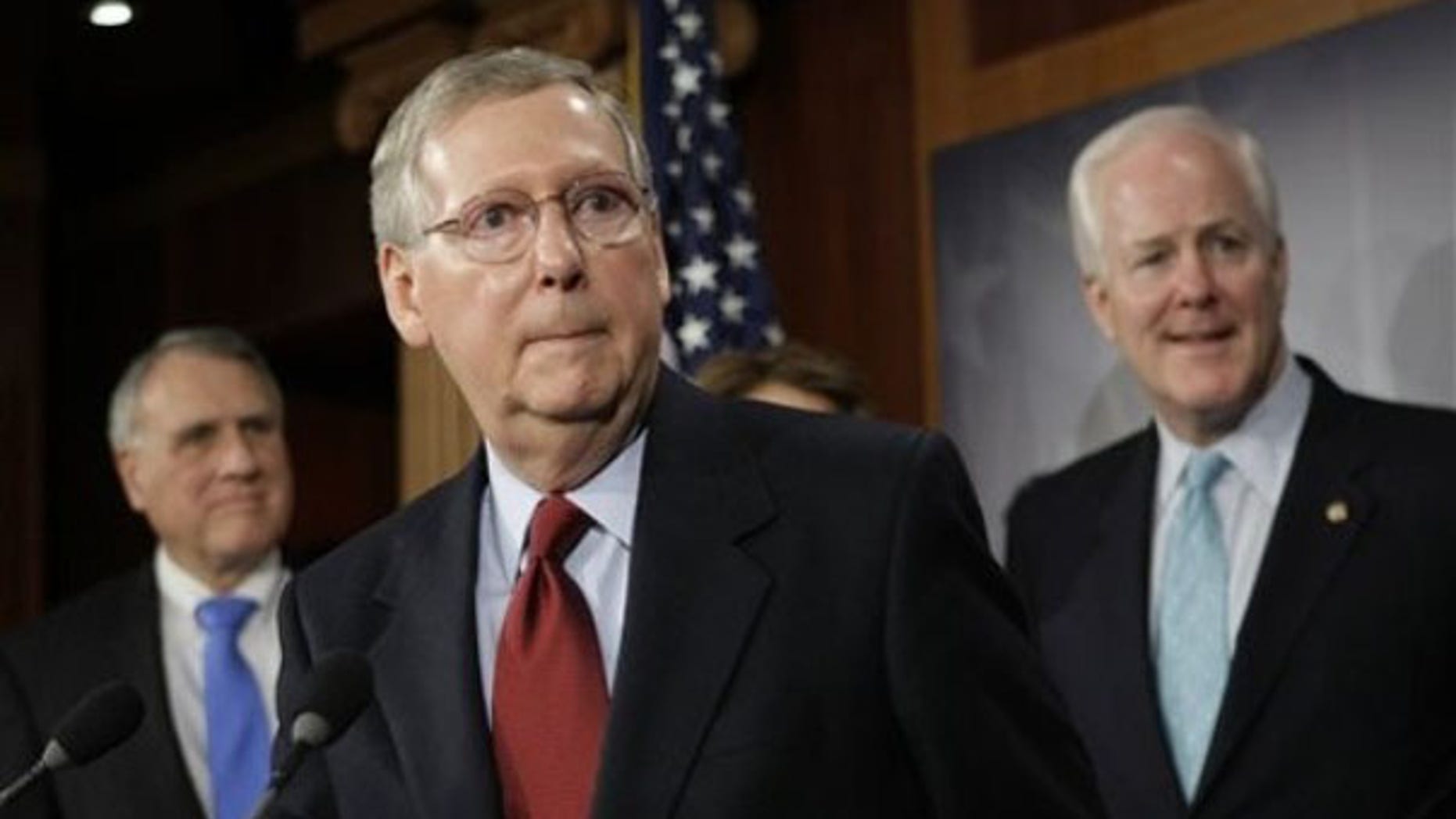 Sen. Mitch McConnell, center, speaks with reporters on Capitol Hill Jan. 27. (AP Photo)