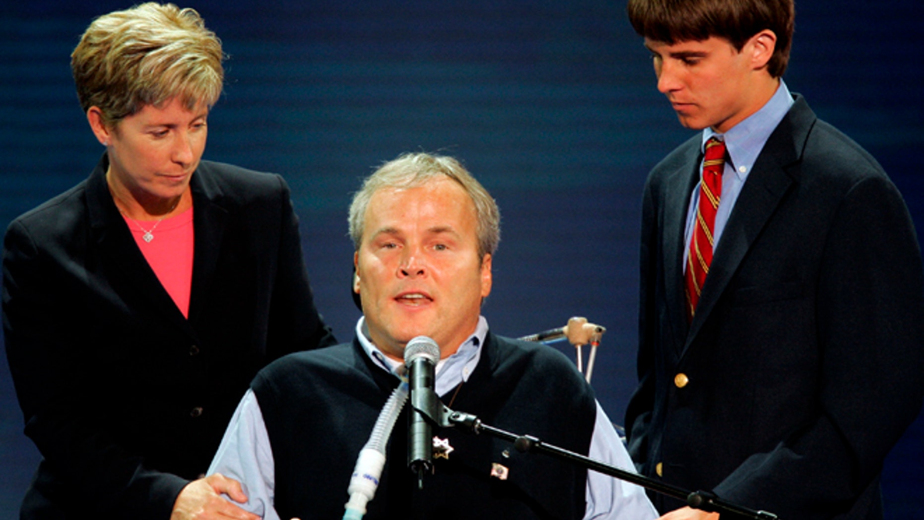 Disabled New York City police officer Steven McDonald is assisted by his wife Patti Ann and son Connor as he speaks during the second night of the 2004 Republican National Convention at Madison Square Garden in New York City, August 31, 2004.