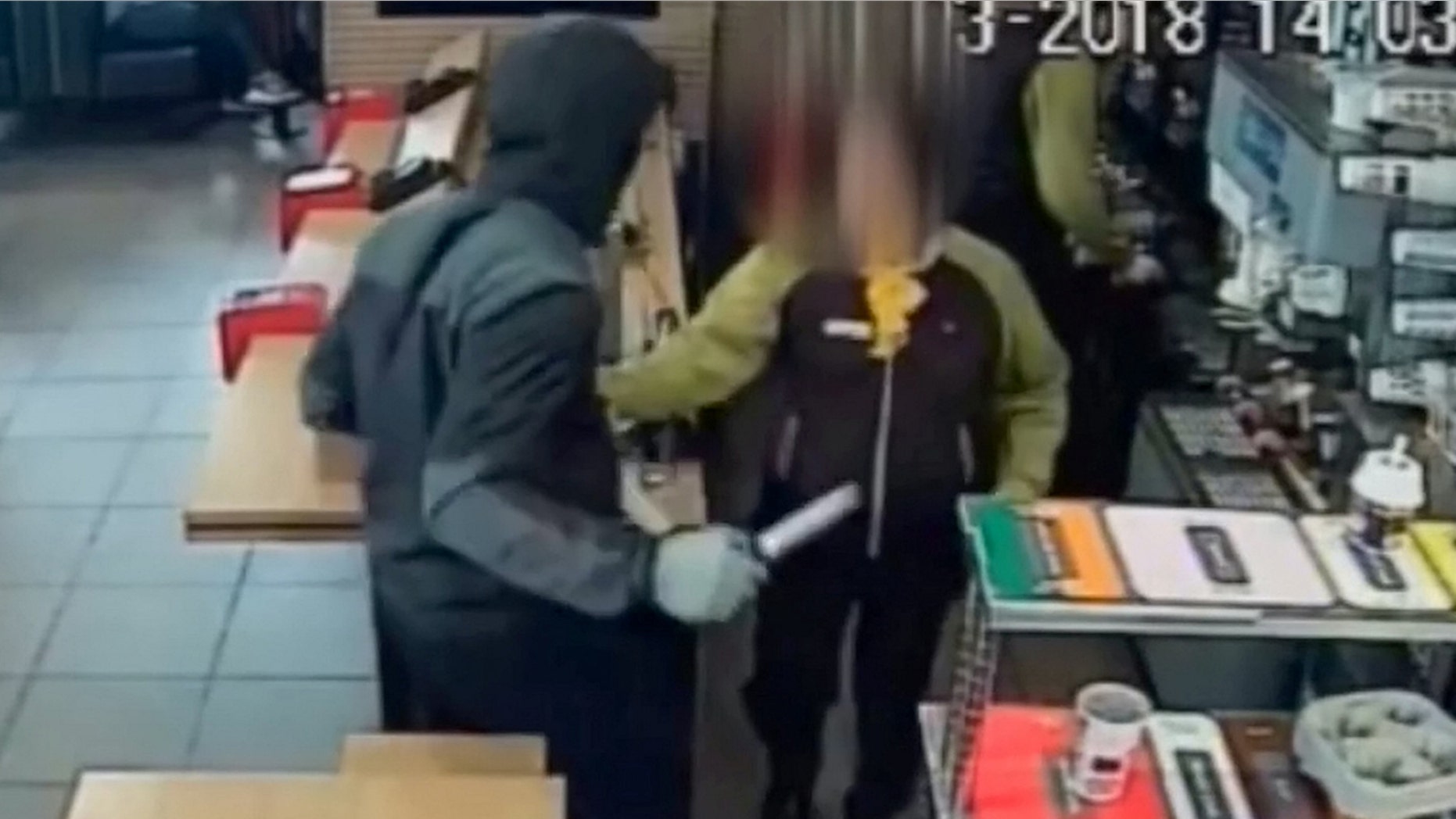A hooded man with a knife stormed into a McDonald's in London and stole a box of Monopoly vouchers.