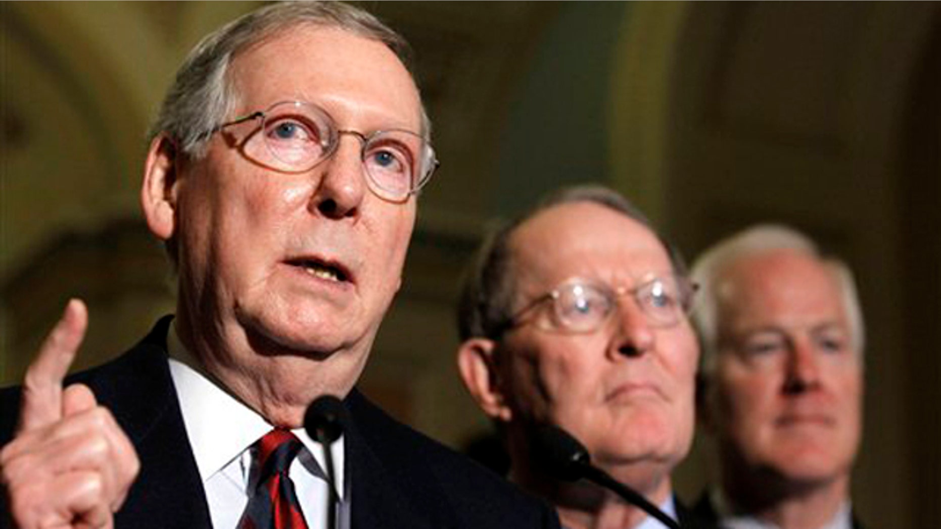 In this Nov. 16 photo, Republican Senate Leader Mitch McConnell, left, accompanied by Sen. Lamar Alexander, R-Tenn., center, and Sen. John Cornyn, R-Texas, speaks at a news conference on Capitol Hill. (AP Photo)