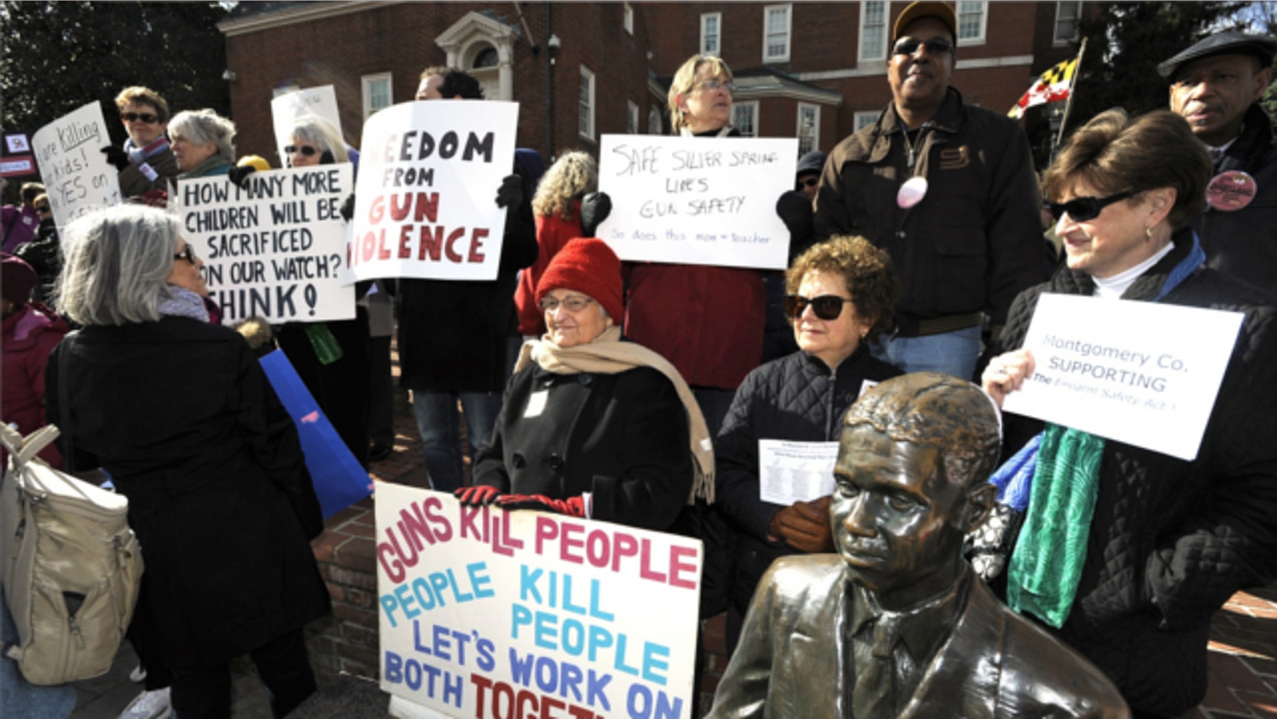 March 1, 2013: Supporters of the Firearms Safety Act wave their signs protesting against gun violence at the Prevent Gun Violence Rally on Lawyer's Mall in front of the State House in Annapolis.