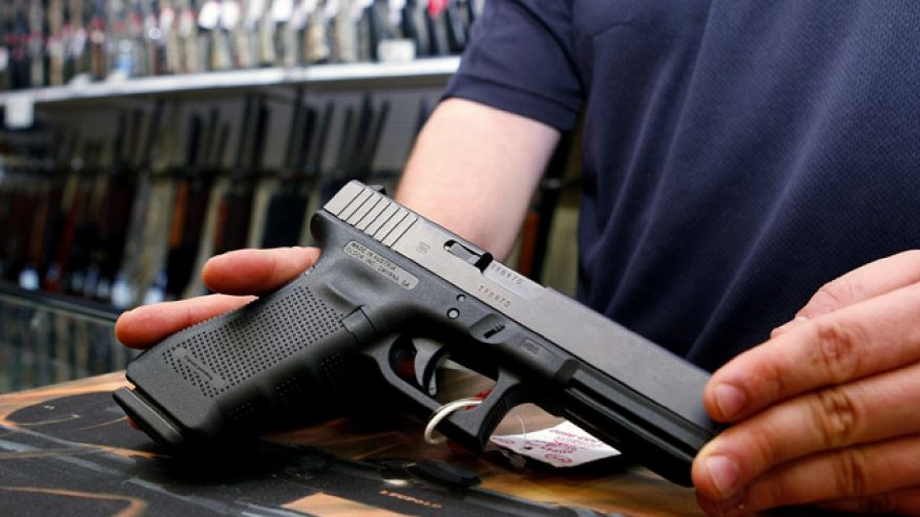 FILE: October 25, 2012: A Glock handgun available in a raffle promotion is shown at Adventures Outdoors in Smyrna, Ga.