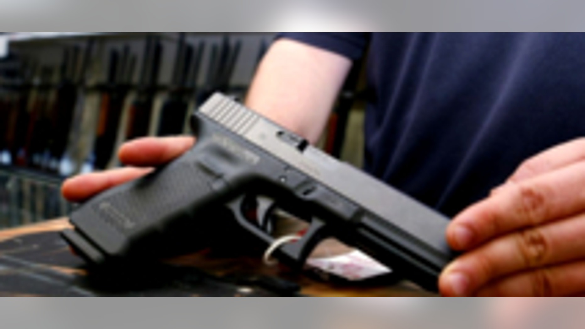 Aug. 24, 2013: A semi-automatic handgun and a holster are displayed at a North Little Rock, Ark., gun shop.