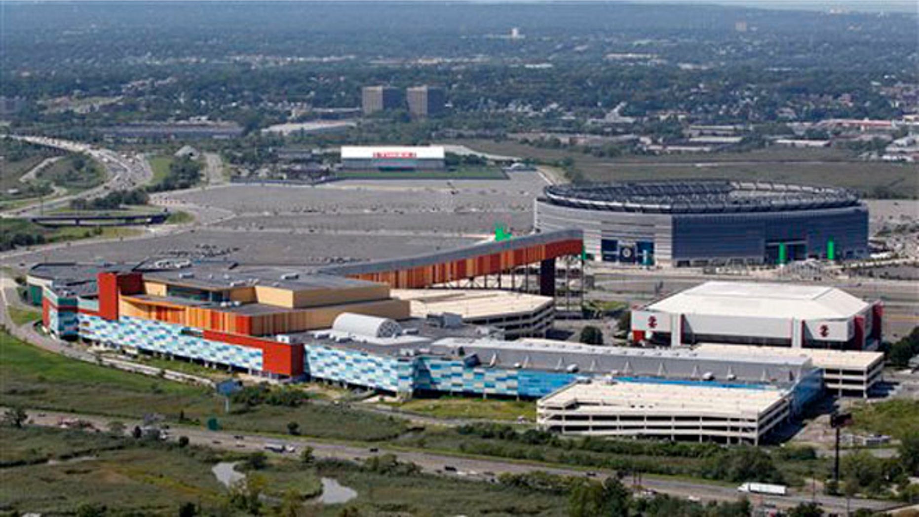 This Sept. 1, 2011 file photo shows MetLife Stadium, rear right, and the Izod Center, middle right, behind American Dream, the unfinished oddly patterned shopping and entertainment complex, in East Rutherford, N.J.