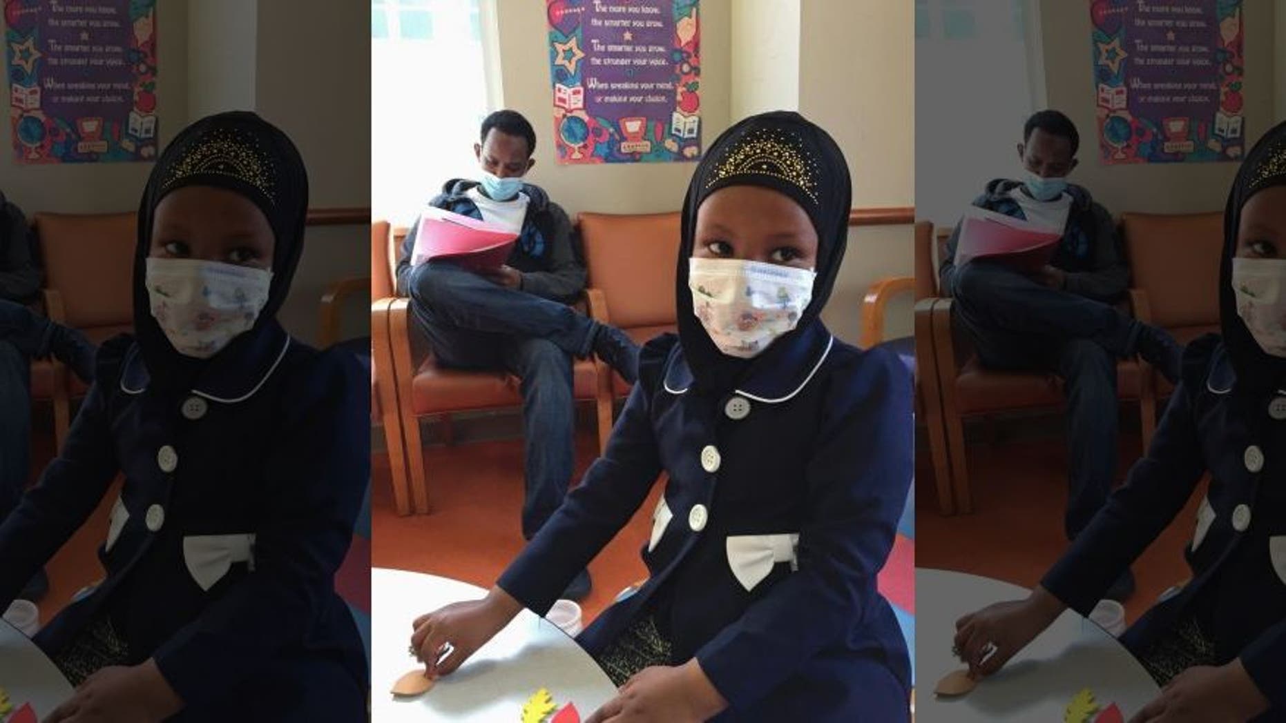 Amira Hassan went to the hospital's clinic for a routine wellness check, but she and her father both had to wear a mask to protect them from measles after an outbreak has sickened more than 30 children in Minnesota.