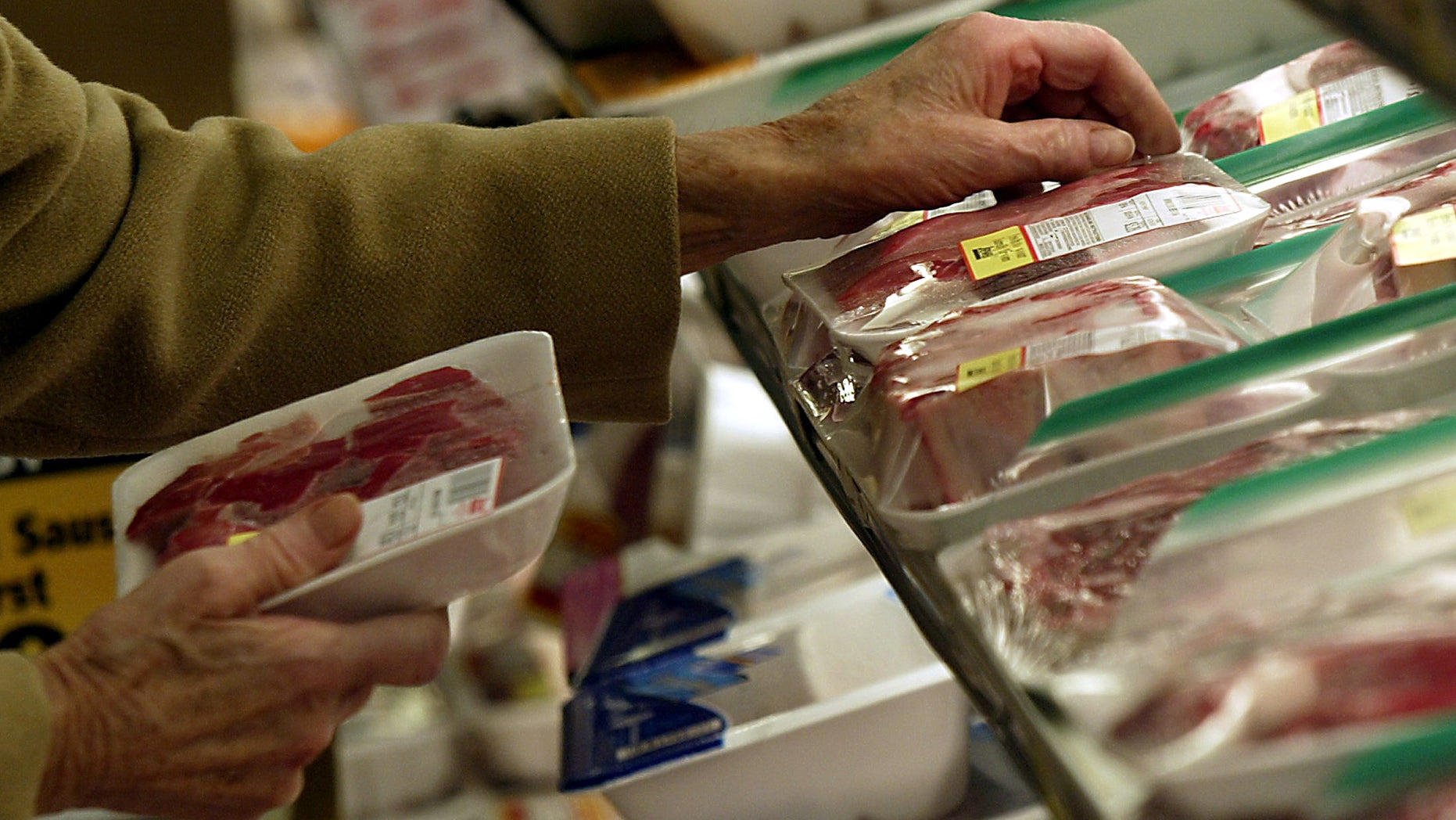 An unidentified shopper looks over the selection of steaks at local grocery store in Chicago. (Reuters)