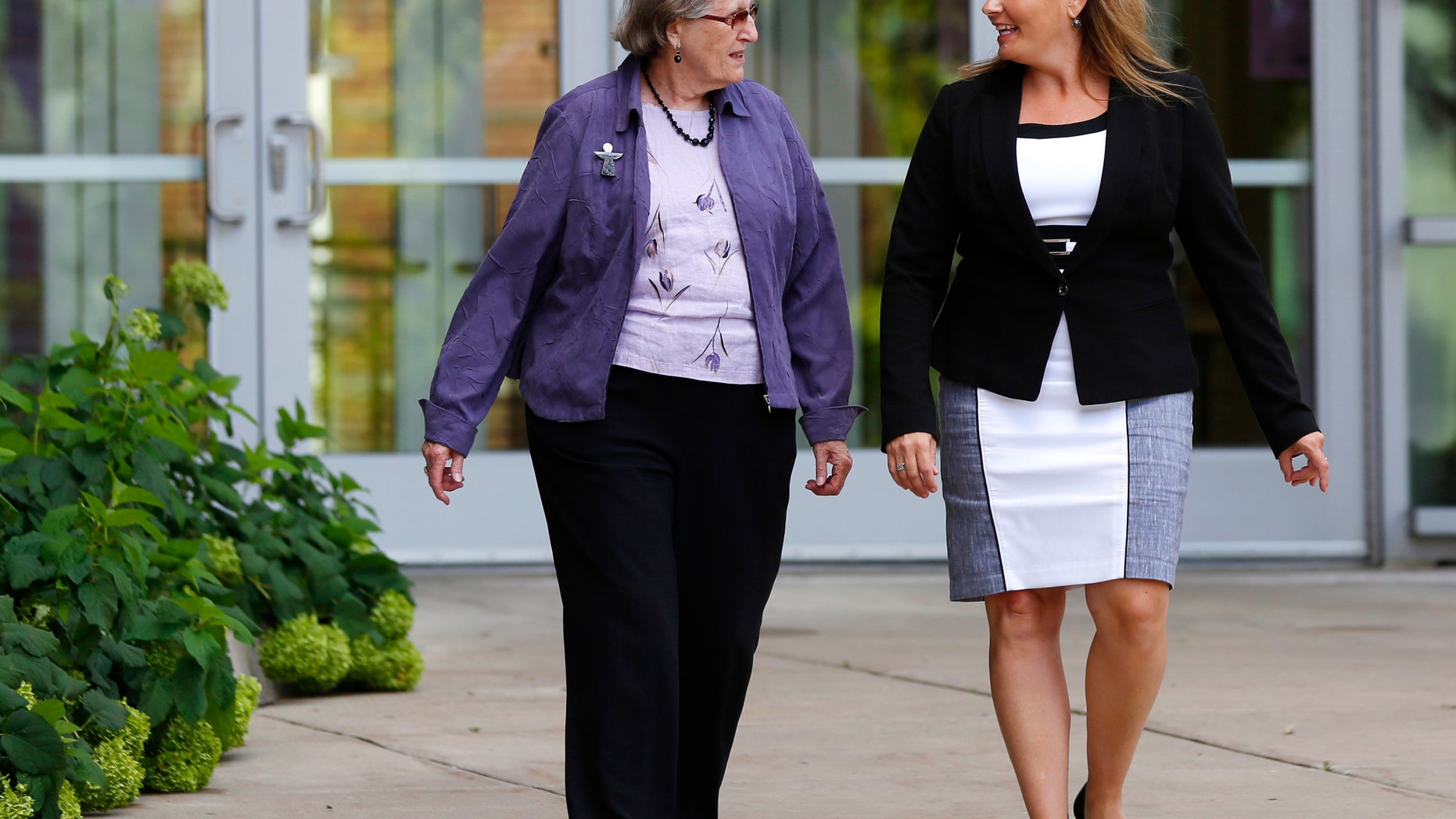 In this Aug. 11, 2016 photo, Angela McArthur, right, director of the Anatomy Bequest Program at the University of Minnesota Medical School, walks with Jean Larson, widow of a donor in Minneapolis. Once a relatively rare option, body donation has surged at medical schools, including the University of Minnesota. The increase has helped provide cadavers for dissection by first-year medical students, and for research and surgical training.