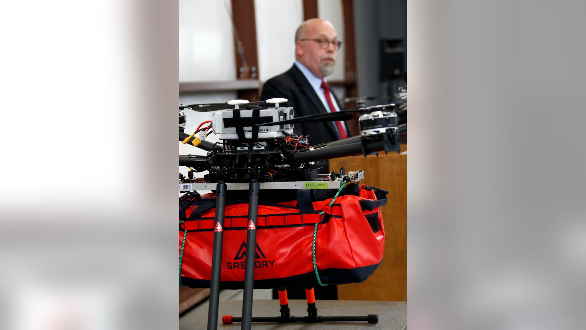 Richard W. Patrick, Senior Advisor for First Responder Policy with the U.S. Department of Homeland Security, looks at the drone equipped with a mass casualty medical kit, as he discusses the potential of life saving medical drones in the field, during a live telemedicine demonstration at John Bell Williams airport in Bolton, Miss., Tuesday, Dec. 6, 2016. (AP Photo/Rogelio V. Solis)
