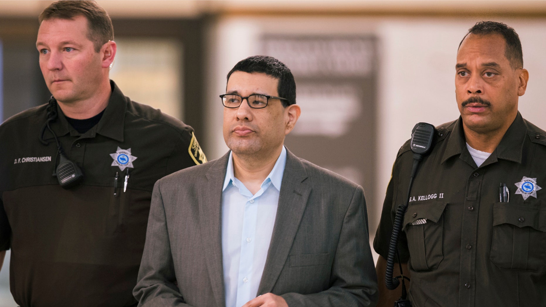 In this Sept. 27, 2016 photo, Anthony Garcia is led by deputies at the Douglas County Court in Omaha, Neb.