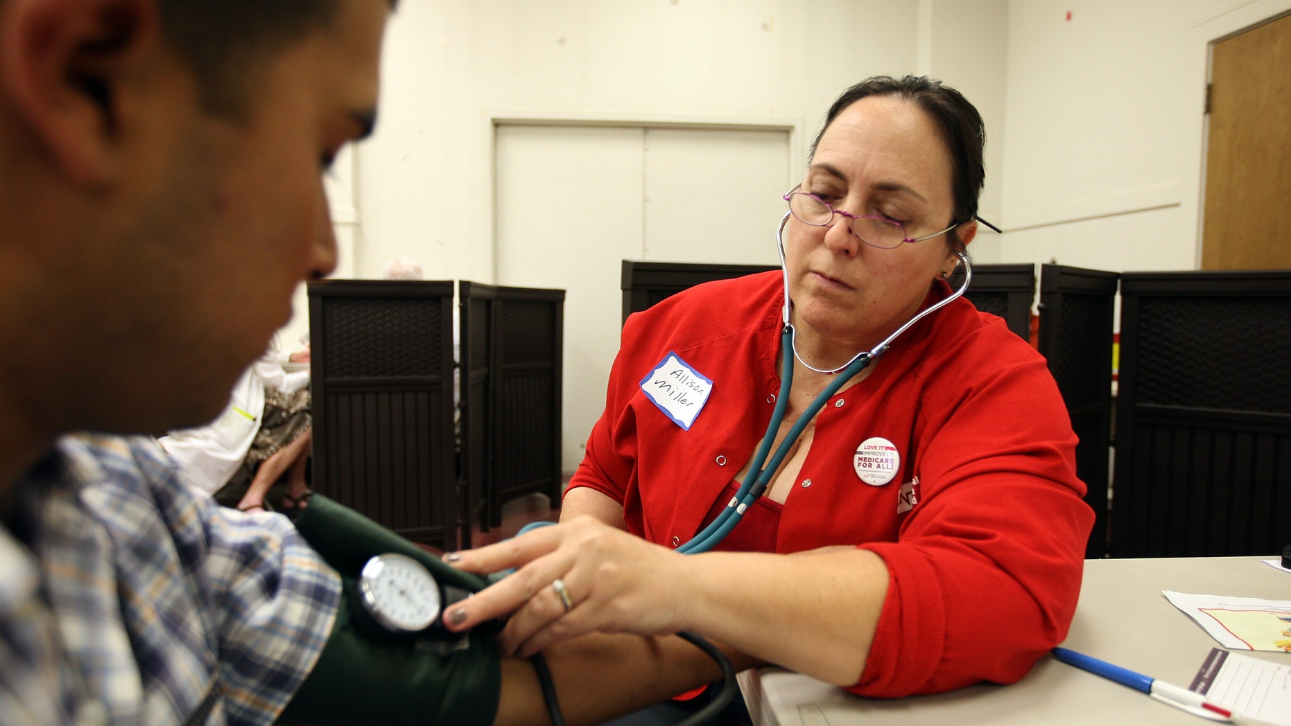 LOS ANGELES, CA - JULY 10: Nurses and physicians give free basic health screenings and call attention to what they say is the ongoing healthcare emergency despite the decision of the U.S. Supreme Court to uphold the Affordable Care Act, on July 10, 2012 in Los Angeles, California. Three days of free screenings in the Los Angeles area are part of the Medicare for All tour which is making up to two dozen stops across California between June 19 and July 12. The California Nurses Association says that 30 percent of Los Angeles County adults are uninsured and 18 percent cannot afford doctor visits. (Photo by David McNew/Getty Images)