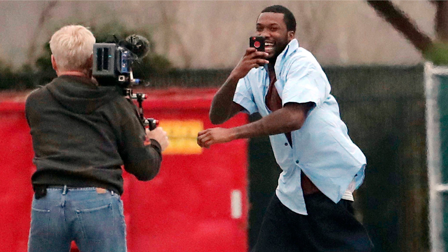 Rapper Meek Mill, right, leaves the State Correctional Institution in Chester, Pa., Tuesday, April 24, 2018.