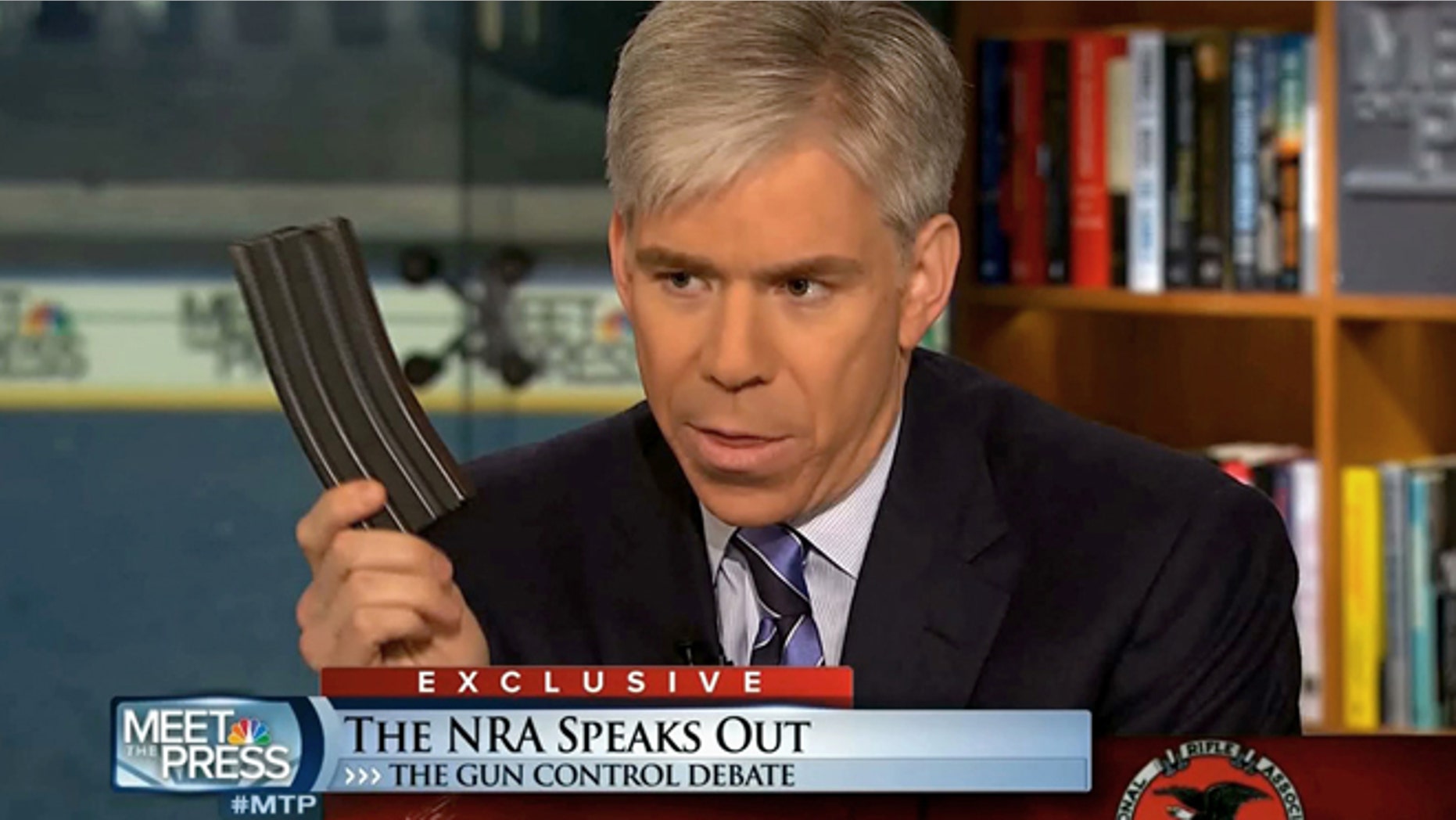 This video frame grab image provided by"Meet the Press" shows host David Gregory holding what he described as a high-capacity ammunition magazine during a recent Sunday's program.