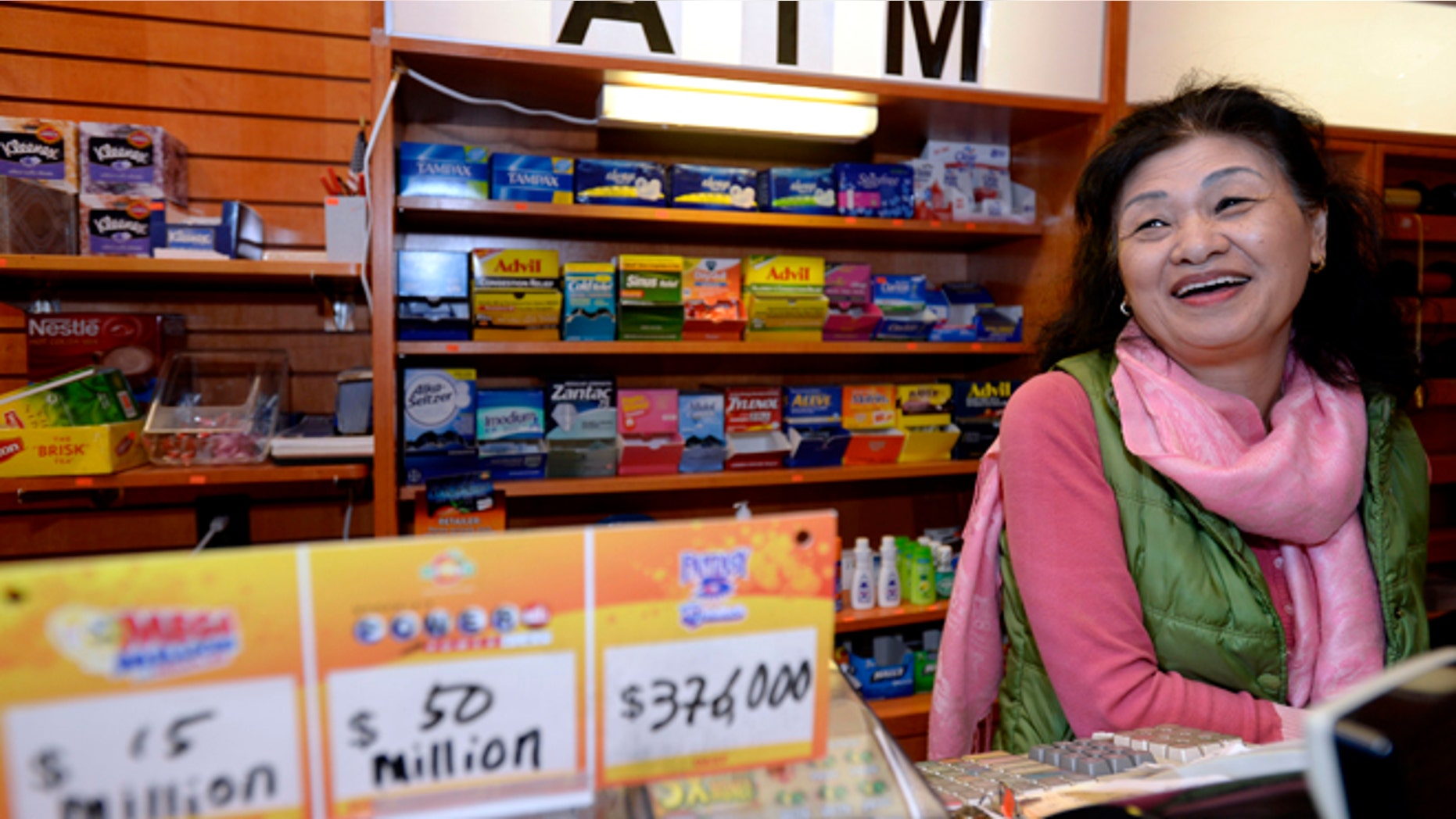 Dec. 18, 2013: Owner Young Soo Lee basks in the attention at her small Alliance Center office bulding newsstand in Atlanta, after lottery officials said one of two winning Mega Millions lottery tickets were purchased from her store in Tuesday's drawing.