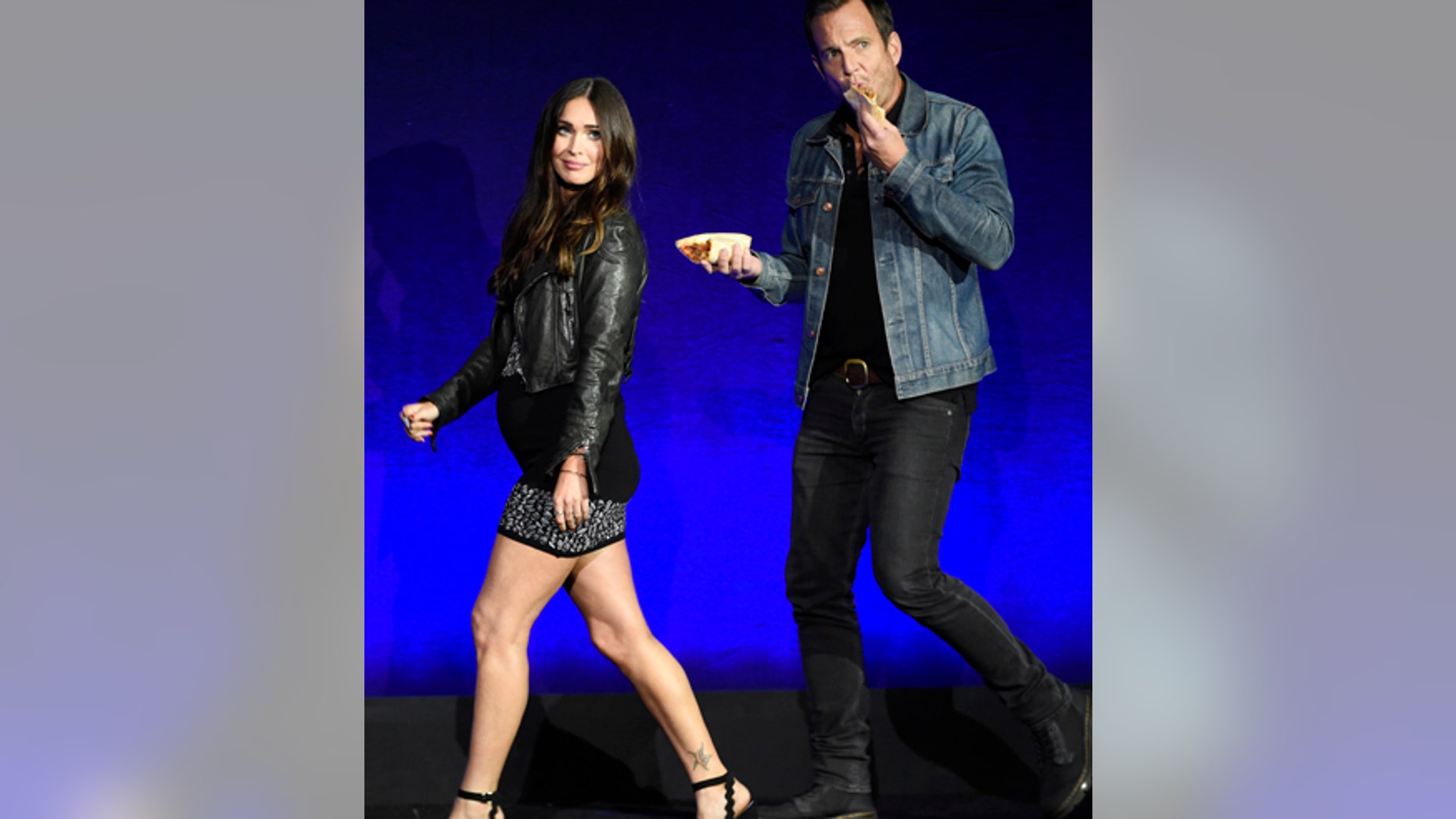 Megan Fox, left, and Will Arnett, cast members in the upcoming film "Teenage Mutant Ninja Turtles: Out of the Shadows," take the stage during the Paramount Pictures presentation at CinemaCon 2016, the official convention of the National Association of Theatre Owners (NATO), at Caesars Palace on Monday, April 11, 2016, in Las Vegas, NV.