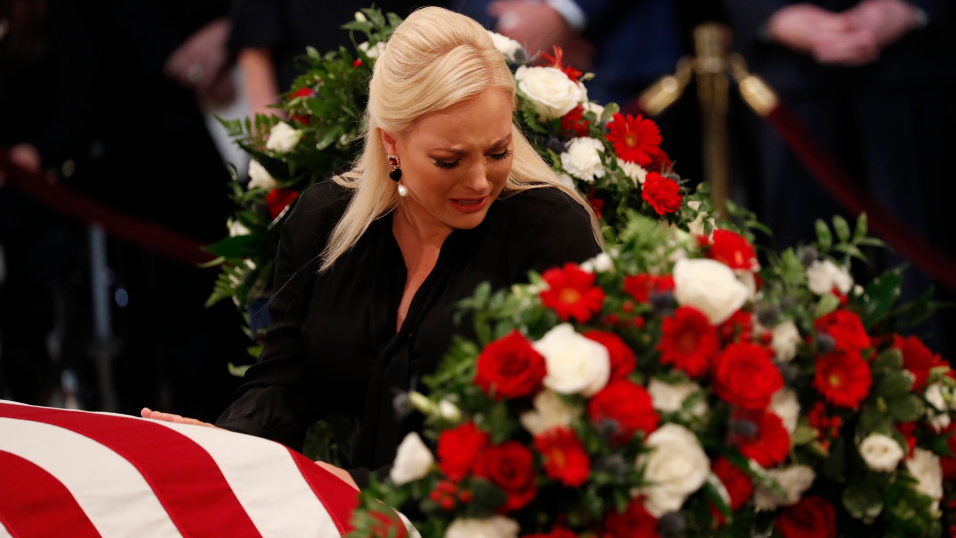 WASHINGTON, DC - AUGUST 31: Meghan McCain, daughter of late U.S. Senator John McCain, touches her father's casket during ceremonies honoring the late US Senator John McCain inside the Rotunda of the U.S. Capitol, August 31, 2018 in Washington, DC. The late senator died August 25 at the age of 81 after a long battle with brain cancer. He will lie in state at the U.S. Capitol Friday, a rare honor bestowed on only 31 people in the past 166 years. Sen. McCain will be buried at his final resting place at the U.S. Naval Academy on Sunday. (Photo by Kevin Lamarque-Pool/Getty Images)