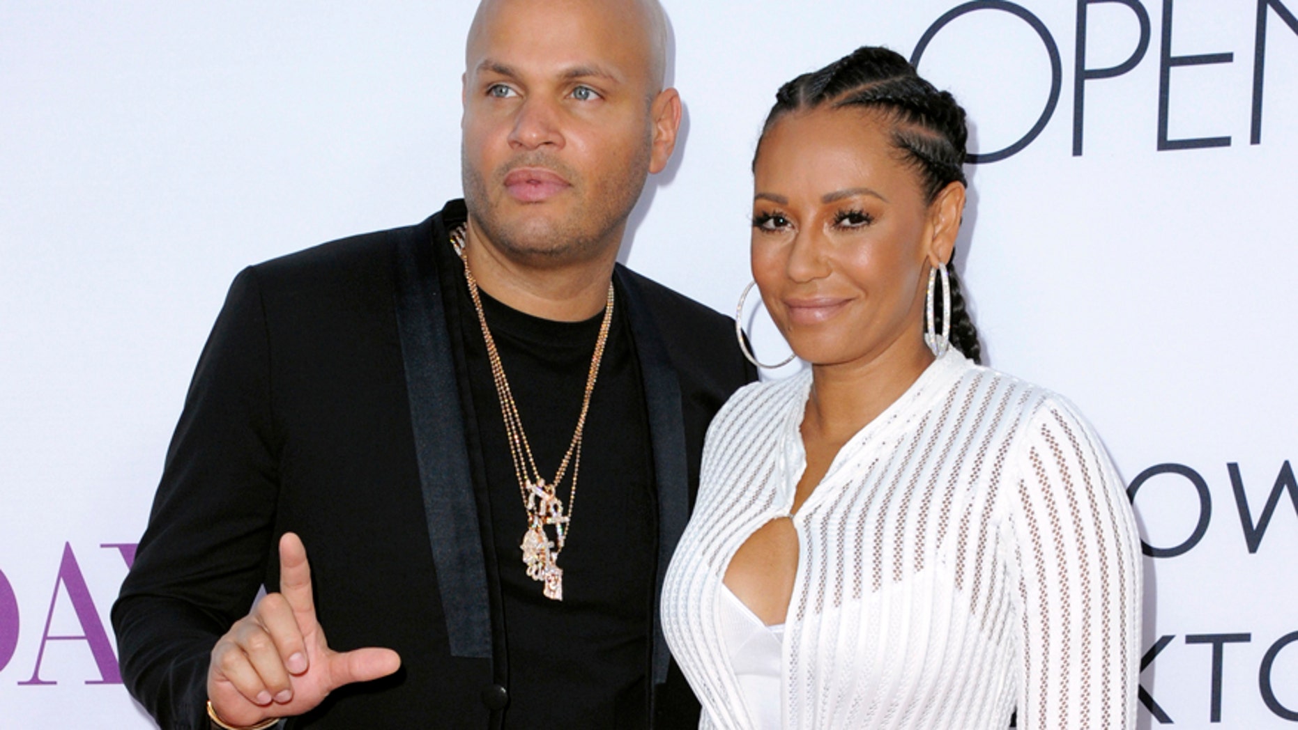 In this April 13, 2016 file photo, Stephen Belafonte, left, and his wife Melanie Brown arrive at the Los Angeles premiere of "Mother's Day." Court records in Los Angeles show the singer and "America's Got Talent" judge filed for divorce from her husband of nearly 10 years, Stephen Belafonte, on Monday, March 20, 2017.